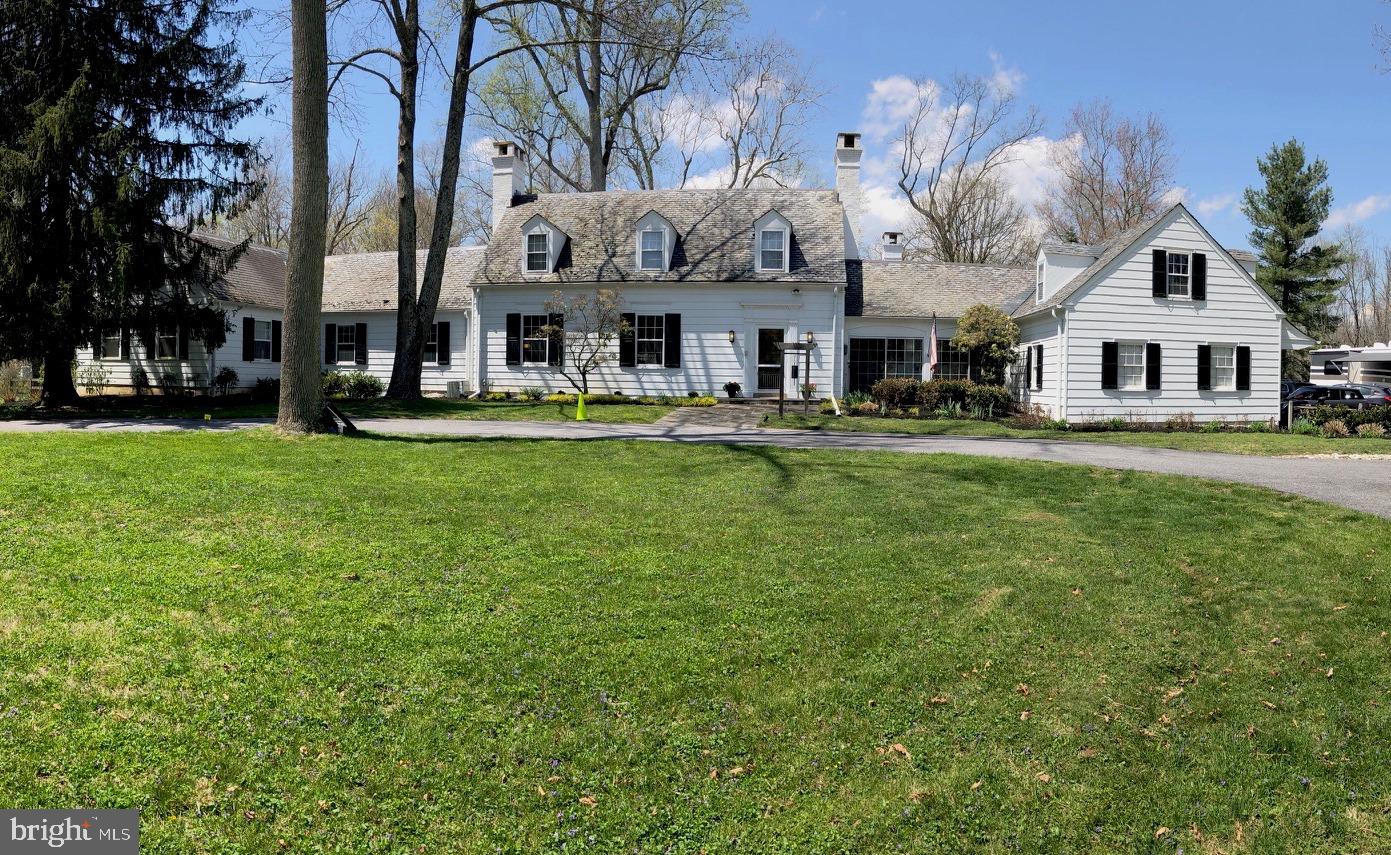 BACK ON THE MARKET AND REDUCED!  Lovely sprawling home located on 4.13 park like acres in historic Caves Valley.  Enter through the private gated circular driveway that leads you to this beautiful home and grounds.  The spacious living room and dining room boast many windows and french doors that provide great natural light and views of the tranquil backyard and stream.  Tremendous entertaining areas spill onto the beautiful hand-cut bluestone patios. Original 1936 details include dentil moldings, wainscoting, built-ins, and ornate fireplace mantels.   Cooking is easy with the two GE Profile stoves (one is convection) in the eat-in kitchen.  Adjacent to the kitchen are a wet bar with wine refrigerator and a butler's pantry with plenty of storage!  Curl up in the master bedroom located on the main level with en-suite, walk-in closet and gas fireplace.  Across the hall is a second master with woodburning fireplace.  This grand bright room could transfer into an artist studio or family room.  The second level features two large bedrooms, full bath and a hallway of closets.   Other amenities include dog run, fitness room, three season porch, library and lower level workroom. Wait there is more!  An in-law suite with separate entrance, living room, kitchen, bedroom and full bath over the 3-car garage!  Remember your horses are welcome too!  The Morton barn with water, electricity and two stalls lead to two paddocks. The barn could be easily converted to a garage or workshop!  Don't miss this exceptional opportunity! https://youtu.be/lixdOB64u8E