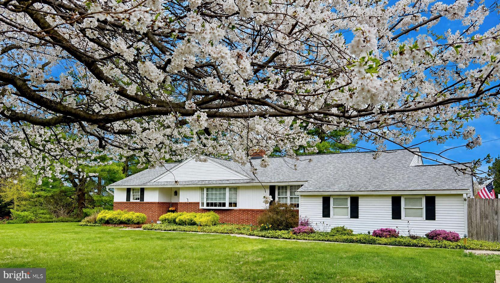 Beautifully maintained and thoughtfully updated, this exceptional ranch home offers effortless one-floor living, situated on nearly an acre in one of Bucks County's most desirable locations, just moments from shopping and the charm of Newtown Borough. Blending comfort, accessibility and convenience, this 3-bedroom, 2-bath residence is ideally positioned with easy access to most major highways.  Inside, gleaming hardwood floors extend throughout, leading into a sun-filled living room with a stunning bay window and a gas-converted fireplace, creating a warm yet elegant focal point.  The open floor plan flows seamlessly into the dining room, ideal for everyday living and entertaining. The updated eat-in kitchen is as functional as it is stylish, featuring granite countertops, a center island, gas cooking, and abundant cabinetry. A true highlight of the home is the four-season room with an attached greenhouse, perfect for year-round enjoyment or the avid horticulturist, opening to a paver patio with new awning for effortless indoor-outdoor living. The primary bedroom features a well-proportioned layout with dual closets and an updated, expanded en-suite bath. Two additional bedrooms offer flexible space for guests, a home office, or both. The refreshed hall bath is filled with natural light and showcases a clean, modern finish. Storage is truly abundant with generous closets, a walk-up attic with future finishing potential, and a spacious basement complete with a workbench and air compressor, ideal for hobbies, projects, or organization.  Additional features include an attached 2-car garage, expanded driveway, maintenance-free exterior, updated mechanical systems and newer roof. This exceptional home offers easy living, tasteful updates, and room to grow in a premier location known for its convenience and appeal.