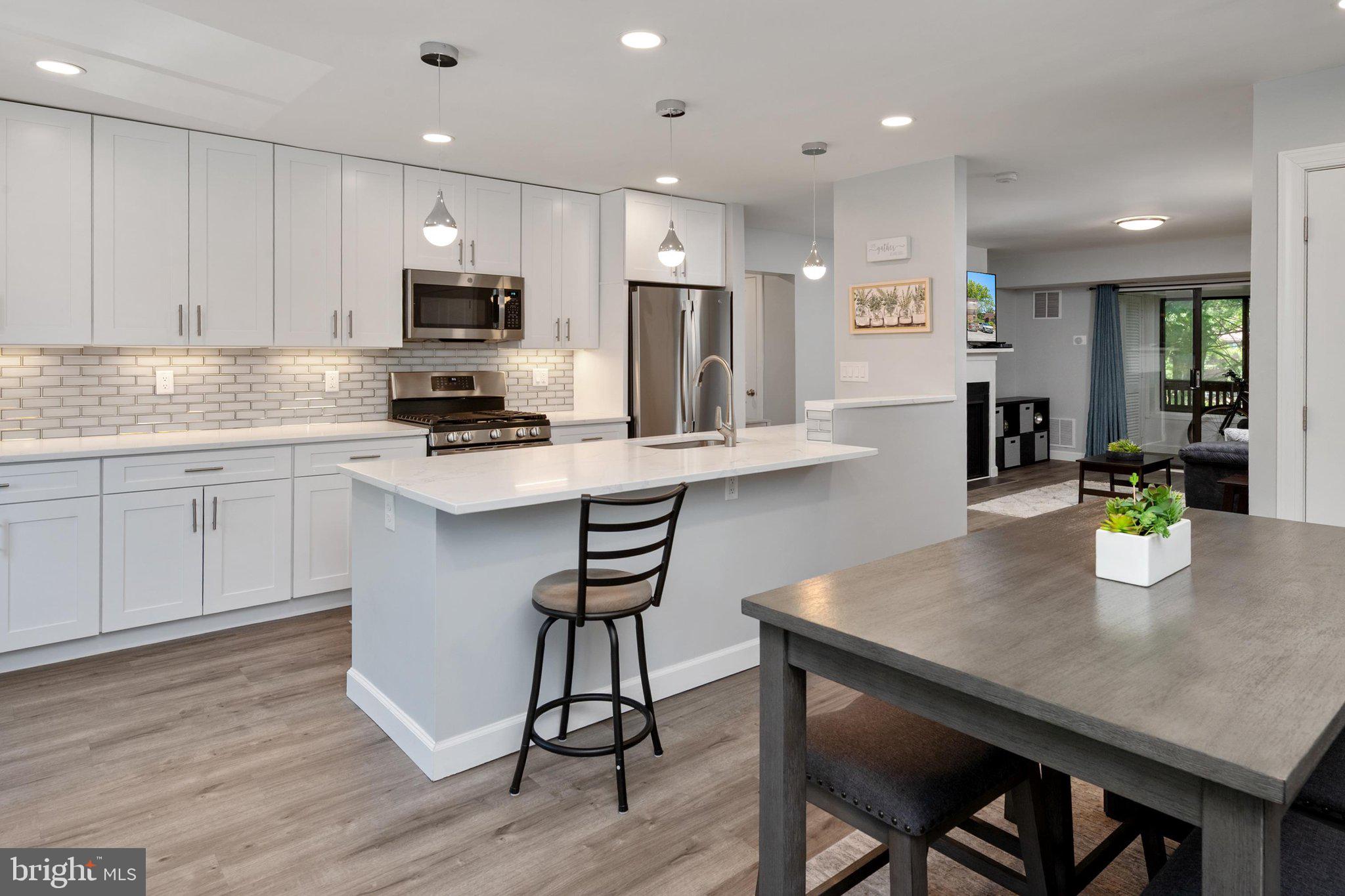 Welcome to Running Brook, nestled in the heart of Columbia, where sophisticated design meets exceptional convenience. This beautifully renovated 2-bedroom, 2-bath condominium offers a rare combination of timeless finishes, thoughtful upgrades, and an open-concept layout designed for modern living.

Completely reimagined and renovated by architect in 2023, this exceptional residence showcases quality craftsmanship and attention to detail throughout. The stunning kitchen seamlessly connects to the living and dining areas, creating an inviting space for both everyday living and entertaining. Elegant white cabinetry, quartz countertops, stainless steel appliances, a designer backsplash, under-cabinet lighting, and pendant lighting over the island create a sophisticated focal point for the home. Luxury vinyl plank flooring extends throughout the main living areas, while new carpeting adds warmth and comfort to the spacious bedrooms. Custom white wood doors, custom closet shelving, and dimmable lighting throughout further enhance the home's refined design.

No detail was overlooked during the renovation. Both beautifully updated bathrooms feature modern finishes and thoughtful upgrades. Additional highlights include a full-size side-by-side washer and dryer, motion-sensor lighting in closets and the laundry room, abundant storage space, all-new plumbing and electrical systems, and a new roof installed in 2024.

Ideally positioned in the heart of Columbia's vibrant lifestyle offerings, this residence is within walking distance of The Mall in Columbia and just minutes from Lake Elkhorn, Lake Kittamaqundi, and Wilde Lake. Enjoy easy access to Columbia's extensive walking and biking trails, local dining, shopping, entertainment, and concerts at Merriweather Post Pavilion. With convenient access to Routes 29, 32, and I-95, commuting throughout the DMV is effortless.

Whether you're seeking a stylish primary residence, a turnkey corporate relocation opportunity, or an exceptional investment property, this home offers the perfect blend of luxury, convenience, and location. A truly rare opportunity to own a fully renovated residence in the center of everything Columbia has to offer.