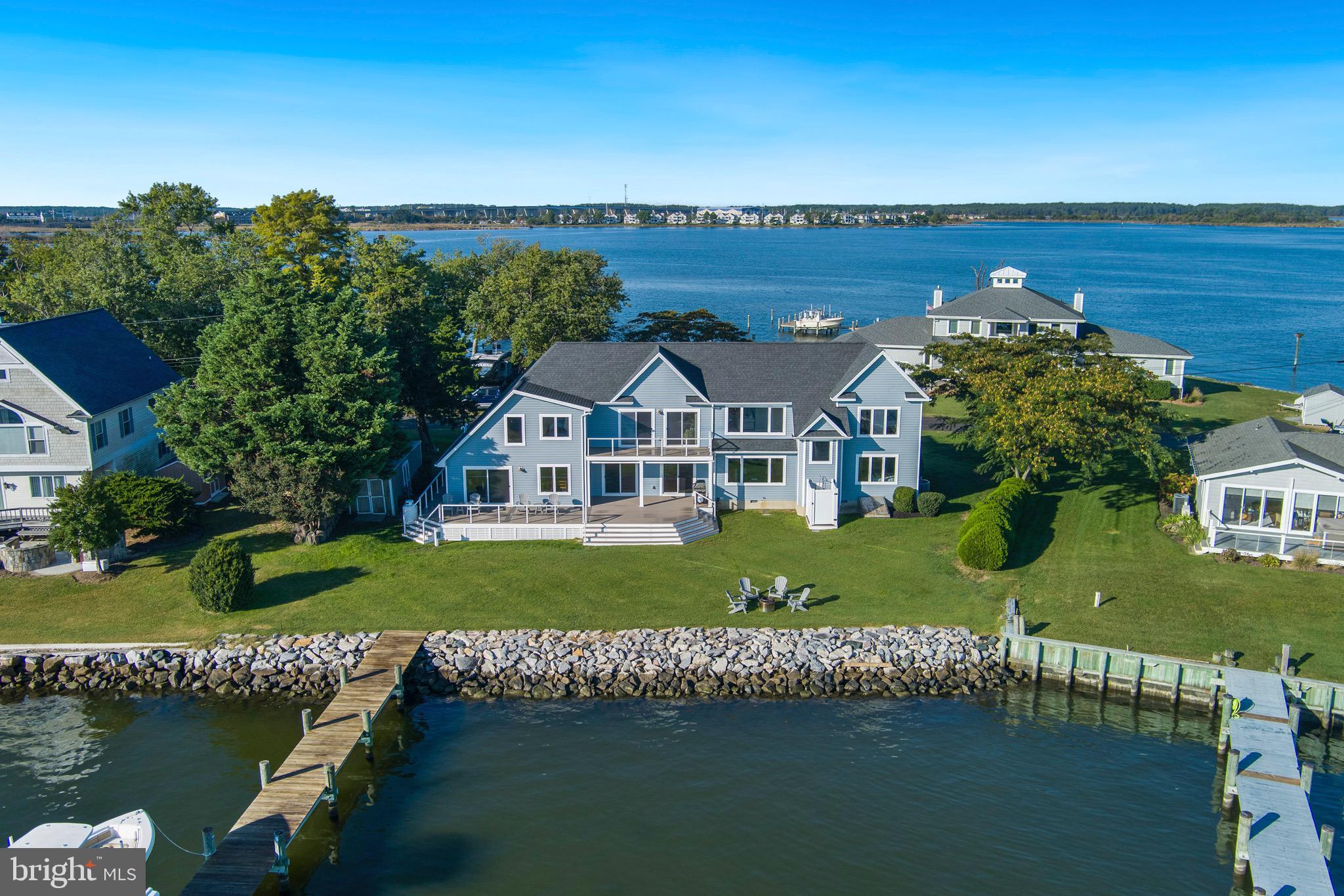 Welcome to 1026 Long Point Road, Grasonville, MD — a waterfront retreat on the Chester River with sunrise out back and sunset out front. Completely renovated inside and out in 2017, this 6-bedroom, 5.5-bath home combines timeless coastal charm with modern updates, offering water views from every room. The renovation included a new roof, siding, windows, HVAC, hardwood floors, carpet, doors, appliances, bulkhead, pier, boat lift, and decks — truly turn-key and ready for years of enjoyment. Designed for entertaining, the main level features expansive living and family rooms, a large dining area plus breakfast nook, and multiple sliders leading to the waterside deck with sleek cable railing. The spacious kitchen opens seamlessly to the deck—ideal for gatherings that flow from indoors to out. There are two bedrooms and 3 full bathrooms on the main level. A large laundry room and a versatile office (or additional bedroom) complete the first floor. Upstairs, two primary suites each offer en-suite baths and water views, separated by a comfortable sitting area. The main primary suite includes a private balcony overlooking the river. An additional guest bedroom upstairs with a half bath provides even more space for family or visitors. Outside, the private pier with an 8,000 lb. boat lift and 4–5 ft. MLW invites effortless boating, crabbing, and fishing right from your backyard. A shed provides extra storage for gear and equipment. Located near the end of the Long Point peninsula, where homes rarely come available, this property offers privacy and proximity to everything you love about the Eastern Shore—walk or bike the Cross Island Trail, easily boat to Kent Narrows, Rock Hall, Chestertown, and St. Michaels, and enjoy quick access to Route 50/301, shopping, restaurants, and nightlife. Whether you’re looking for a primary residence, weekend escape, or vacation rental investment, 1026 Long Point Road delivers the perfect blend of comfort, convenience, and Chesapeake charm.