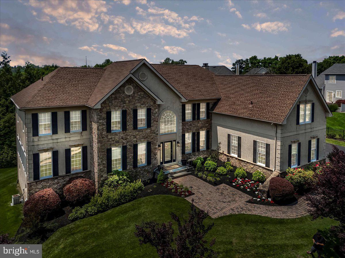 For the discerning buyer, welcome to 22 Thomas Speakman Drive—an extraordinary residence tucked away in the prestigious Garnet Valley Woods community of Glen Mills, PA, within the highly acclaimed Garnet Valley School District. This fully upgraded luxury home offers over 7,000 square feet of impeccably crafted living space, enhanced by elegant custom millwork and recently transformed under the direction of a professional interior designer. Every detail has been thoughtfully curated, from fresh designer-grade paint and all-new premium hardwood flooring and plush carpeting to custom lighting—including LED recessed lighting throughout—and refined, high-end finishes at every turn.  At the heart of the home lies a show stopping chef’s kitchen, complete with professionally refinished cabinetry, quartz countertops, a custom herringbone ceramic tile backsplash, and top-of-the-line stainless steel appliances—including a refrigerator, double ovens, a cooktop with downdraft exhaust, dishwasher, and both standard and touch-activated faucets. Under-cabinet lighting and custom shelving in the walk-in pantry add both elegance and function.  The main level also features a private home office with custom-built-ins, a formal living room, an elegant dining room, and a sun-drenched step-down conservatory with dramatic floor-to-ceiling windows. Adjacent to the kitchen, a bright solarium leads to a spacious rear deck overlooking a plush, private backyard—perfect for entertaining or relaxing in style. The two-story family room impresses with soaring atrium windows fitted with remote-controlled custom blinds, a floor-to-ceiling stone gas fireplace, den/sitting room, and a sleek custom-designed wet bar. Completing the main level are a designer powder room, large laundry room, and a three-car garage with a premium epoxy-coated floor.  Upstairs, the luxurious primary suite is a true retreat, featuring two expansive California walk-in closets and a spa-inspired bath with a jetted soaking tub, a custom steam shower with triple shower heads and frameless glass doors, and a private commode room. Three additional bedrooms each offer their own en-suite baths and private bonus rooms—perfect for guests, hobbies, or home study spaces.  
The finished walk-out lower level is an entertainer’s dream, offering  over 2000 additional square feet of living space that features a state-of-the-art home theater, separate game room with arcade machines (most included), a full gym with equipment, a billiards area with pool table, wet bar, a fifth bedroom with full bath, and ample storage space.  Truly better than new construction, this exceptional home is being offered fully furnished—including all furniture, wall hangings, all lighting fixtures and most personal property are included—along with artwork, TVs, a premium sound system with over 35 ceiling speakers, gym equipment, most arcade machines, and a sprinkler system featuring 40 heads. Turn-key and one-of-a-kind, 22 Thomas Speakman Drive is a rare opportunity to own a designer masterpiece in one of Glen Mills' most sought-after neighborhoods.  Do not miss your chance to call this extraordinary property home.  Owner is a Licensed PA Real Estate Salesperson.