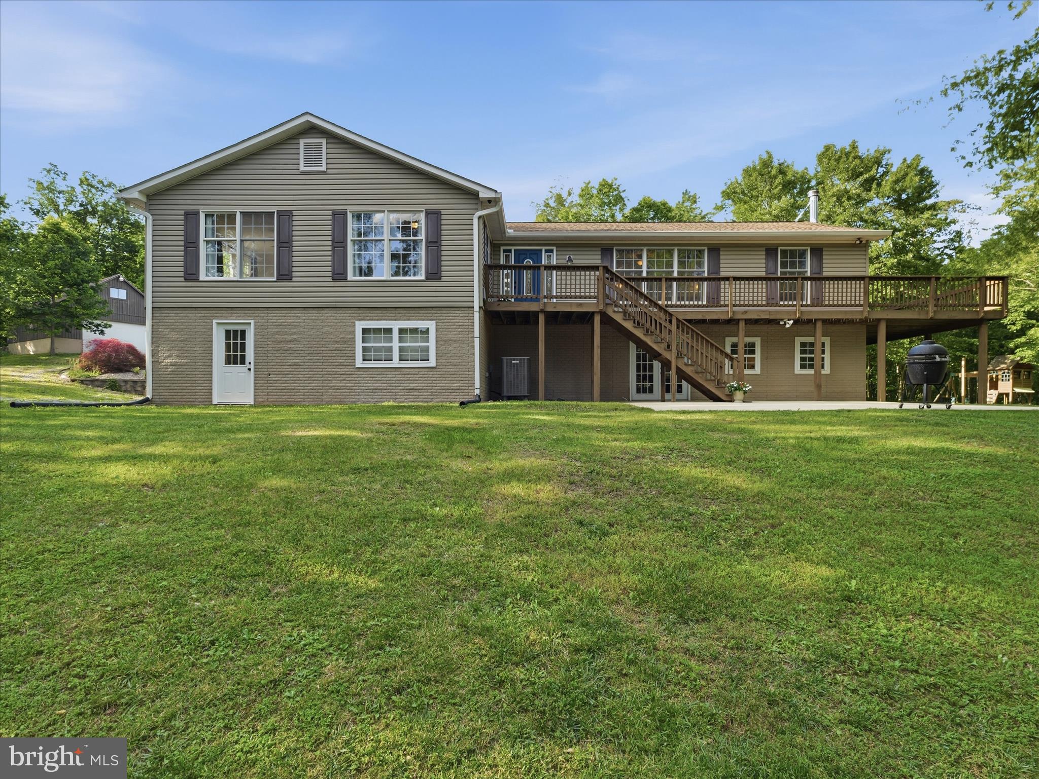 This charming home on over 6 acres of partially wooded property with a meandering stream offers privacy and the calming effects of nature. The 5 bed, 3.5 bath home affords main level living, with the added bonus of extra living space in the large walkout basement. The upstairs of this ranch home, with its beautiful hardwood floors, features an open, expansive kitchen and dining room layout, with plentiful cabinet and counter space, plus room for an island! Real wood cabinets, granite countertops and breakfast bar seating elevate the look of the kitchen, and make it a space you will love to spend hours entertaining in! The half bath is conveniently located at the end of the kitchen near one of numerous entrances to the wraparound deck. The spacious living room allows for large social gatherings, or a quiet evening at home enjoying the solitude. One primary suite and two generously sized secondary bedrooms, plus the second (and large!) full bathroom, are located down the hall. The primary suite has a double vanity, separate shower and toilet room and plenty of closet space. A fourth main level bedroom is located off the living room, with its own entrance to the primary bedroom, making it a fantastic flex space that could be also be used as an office or craft room! Head downstairs to more flexible space to be used in whatever way suites your needs best! A family room with french doors leading to outside and a full bedroom and bathroom have new luxury vinyl plank flooring for easy cleaning and room for guests! The equally large, unfinished side of the full basement is open to your creativity. With another set of exterior french doors and two large windows allowing for extra light, you can use your imagination to dream up a game room, exercise room or use for whatever your hobby may be! As if that doesn't seem like an overabundance of space, there is yet ANOTHER unfinished storage room on the lower level. Back outside, enjoy the forest views from your wraparound deck, while embracing the country life in your yard with room for potential livestock or poultry and gardens! Is tinkering in a workshop more your thing? You're in luck! With a 28x30 oversized garage with staircase to a full second-story storage area, the possibilities are endless. There is even existing ductwork in place for those more heavy-duty projects. Be sure to get your showing scheduled so you don't miss out on this opportunity!
