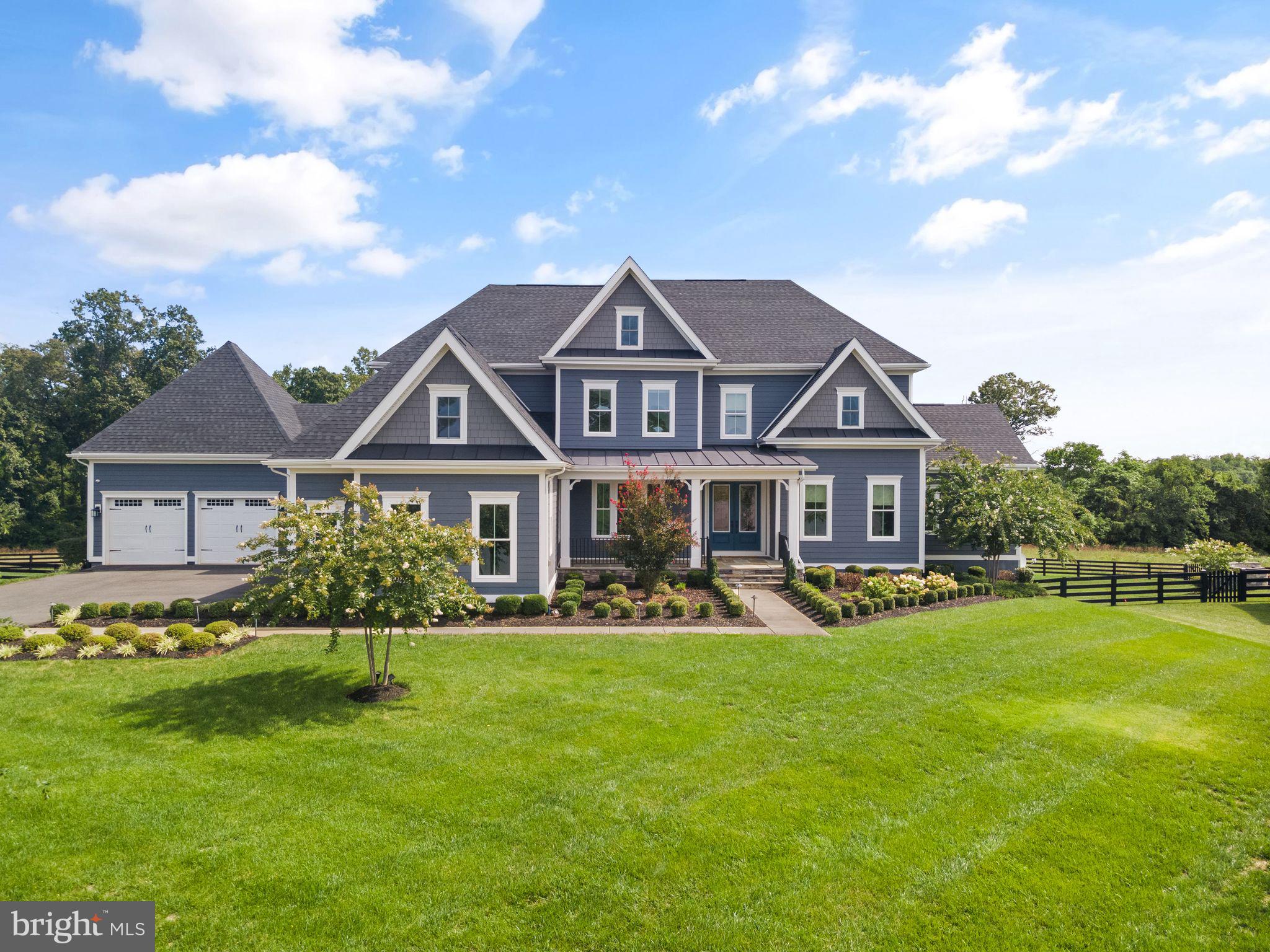 Welcome to this AMAZING, LUXURIOUS ESTATE HOME! This Clifton Park II model by NV Homes boasts over 7,400 sq ft of multi-generational living space, backing to a conservancy lot with a rare five-car garage! From the moment you walk in the front door, you'll be captivated by its charm and elegance. This home truly stands out with all the upgrades selected.

The main floor offers an impressive open floor plan, perfect for connecting with family and friends. The massive two-story family room, with coffered ceiling, stone fireplace, and built-in bookshelves, provides ample space for everyone to relax or entertain. The view from the family room to the backyard is breathtaking, with trees and conservancy space.

The spectacular kitchen features double islands, a cooktop, a pot filler, a double oven, a built-in microwave, a stunning backsplash, a prep sink, and a beverage fridge. The white cabinets provide plenty of storage, and the oversized pantry is a chef's dream. All appliances are the GE CAFE series. The breakfast area, surrounded by windows, bathes in perfect morning sunlight, creating an ideal spot for your coffee. Or step out to the screened-in porch to take in the views of the wooded backyard.

The dining area is stunning and spacious, perfect for hosting gatherings, with an attached butler's pantry with a beverage fridge. Additionally, the main floor includes two dedicated office spaces, a half bath, and plenty of closets. There is a guest suite with a full bath on the main level, as well as main-level laundry. The mudroom features a drop zone, a coat closet, and two laundry/utility rooms.

Upstairs, you'll find four spacious bedrooms, each with its own private bath. The primary suite is an oasis of luxury with a custom closet and a private balcony, perfect for morning coffee. The primary bathroom boasts two separate sinks with ample counter space, a walk-in shower, and a freestanding tub.

The walk-out basement is where all the fun happens, offering ample space for family gatherings and movie nights. It features a rec room with a wet bar and a large pantry, a full bath, a movie room, and storage. There’s also plenty of room to add additional spaces such as an office, gym, or den. The patio in the backyard is perfect for watching sunsets or enjoying the wooded lot views.

The yard spans two-thirds of an acre, offering the perfect size for a pool or anything else you could imagine. The five-car garage features two electric car chargers and epoxy flooring.

The amazing Willowsford Greens Community is a resort-style community offering numerous amenities, including Community Pools, a Clubhouse, a Fitness Center, Community Events, Cooking Classes, Zip Line, Tree Houses, Lakes, Fishing Ponds, Splash Park, Disc Golf, Willowsford Farm, and more! Enjoy easy access to Dulles Airport, Shopping, Restaurants, Vineyards, Commuter Routes, and Metro Rail.