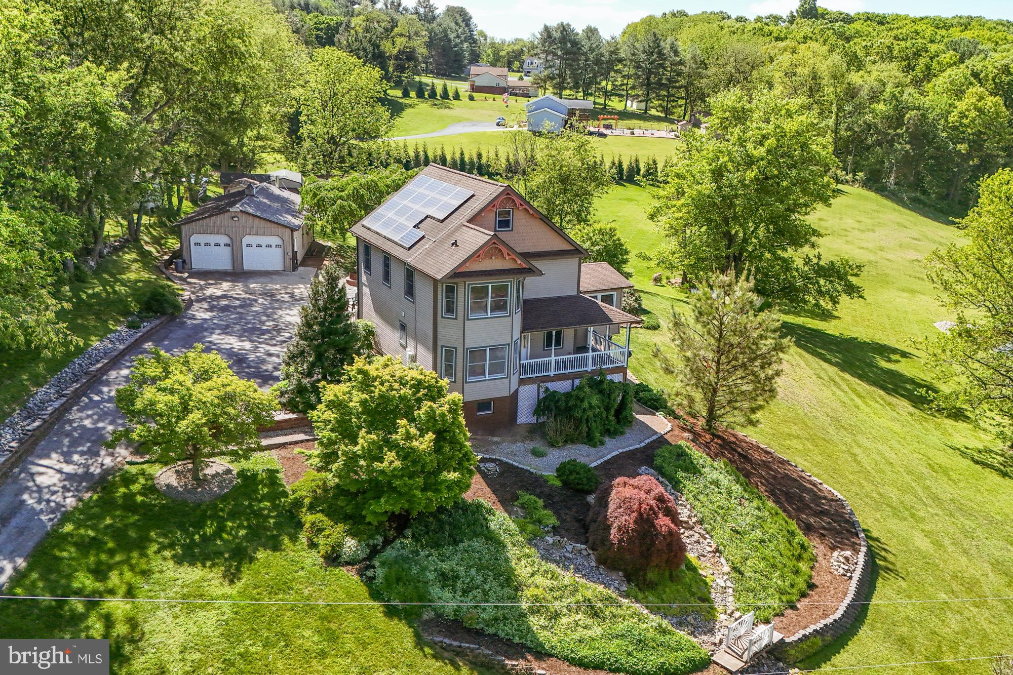 Perched on a picturesque 2-acre setting in sought-after Freeland, this gorgeous Victorian porch-front home offers timeless charm, spacious living, and breathtaking views. Featuring 4 bedrooms and 3.5 baths, this beautifully designed home blends classic elegance with modern comfort. The inviting main level offers a convenient first-floor bedroom with en suite bath, perfect for guests or multigenerational living. The heart of the home is the expansive open kitchen, complete with granite countertops, stainless steel appliances, and a peninsula with seating for four, seamlessly flowing into the large dining area and spacious living room—ideal for entertaining.

The stunning family room boasts a vaulted ceiling and walls of windows that showcase the serene surrounding views. Upstairs, retreat to the luxurious primary suite featuring an en suite bath with a relaxing sunken tub, along with two additional generously sized bedrooms and a well-appointed hall bath. The large walk-out basement offers endless possibilities for additional living space, recreation, or storage.

Outside, enjoy the peaceful beauty of this exceptional property from the classic wraparound porch or explore the expansive grounds. A detached oversized garage provides the perfect space for a car enthusiast, woodworker, or hobbyist. Offering a truly beautiful setting with the perfect balance of privacy, charm, and functionality, this exceptional home is a rare Freeland opportunity.