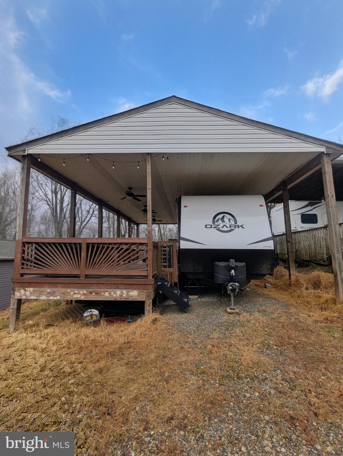 Sewer Lot
This remarkable property includes a fully equipped 2024 Forest River Ozark 2670 RK Camper, perfect for outdoor enthusiasts. The spacious deck is designed for relaxation and entertainment, featuring installed electricity and fans to keep you cool during warm summer evenings. The private backyard is generously sized and seamlessly backs up to a serene wooded area, offering a peaceful retreat and a beautiful natural backdrop. 

This is a secured, gated community, and access begins at the guard shack. Make sure to bring your ID to the office or guard shack for your visitor pass. **THIS IS A SEASONAL CAMPGROUND, OPEN FROM APRIL 1 TO NOVEMBER 1.**

River Bend is a premier, privately owned 400-acre recreational vehicle camp resort designed for seasonal enjoyment. Nestled along the picturesque Upper Potomac River in West Virginia, River Bend stands out as one of the state's most sought-after family destinations, just a short drive from the bustling Washington and Baltimore metro areas. The park is fully operational with utilities from April 1 to November 1, and lot owners enjoy year-round access to their properties.

**Membership Benefits Include**:
- Breathtaking views and diverse wildlife
- Prime access to the Potomac River
- Scenic hiking trails
- Refreshing swimming pools
- Fun-filled mini-golf
- A vibrant youth center
- Well-maintained tennis and basketball courts
- Convenient laundry facilities
- A well-stocked convenience store, deli, and lounge
- Clean and modern bathhouses throughout the park
- A boat ramp for easy water access
- An inviting bar and grill
- A church right on the grounds

At River Bend, the fun never ends! Join in on various exciting activities, including Fourth of July fireworks, a lively carnival, bonfires, poker runs, horseshoe tournaments, car shows, Halloween trick-or-treating, and so much more!