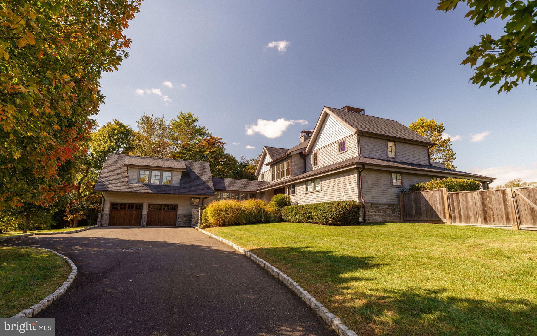 Modern luxury meets timeless design along the edge of the Philadelphia Cricket Club’s historic St. Martin’s golf course. Built in 2018, this 4-bedroom, 5.5-bath home offers 5,636 sq. ft. of refined living space on a private one-acre lot with sweeping fairway and treetop views. A modern take on classic farmhouse architecture, the cedar-shingle exterior and clean lines create an inviting presence ideally located on the 8th hole at The Philadelphia Cricket Club's historic St. Martin's golf course. No expense has been spared in the design and creation of this fabulous residence. Sited on one beautifully landscaped acre, surrounded by 37 acres of green space preserved in perpetuity by The Natural Lands Trust, at the edge of Fairmount Park.

Inside, a dramatic two-story living room with a wall of windows anchors the main level, connecting to a family–dining area with custom Poggenpohl cabinetry, wet bar, and French doors to a covered porch.  The kitchen is a beautifully curated modern workspace, anchored by Poggenpohl cabinetry that defines its clean, architectural lines. Marble countertops and backsplash complement a suite of professional-grade appliances: Wolf range and hood, Wolf microwave drawer, SubZero refrigerator, and Bosch dishwasher. A built-in desk, breakfast bar, and generous pantry offer both practicality and refinement, while the adjacent mudroom with Whirlpool laundry, built-in bench, and garden sink ensures effortless everyday living. A first-floor primary suite provides a serene retreat with a gas fireplace, custom California Closet dressing room, radiant heated marble bath with steam shower and hydrosystem tub, and private porch.

Upstairs, an open loft with stunning views of the golf course and Wissahickon Valley connects to two en-suite bedrooms with gas fireplaces, marble baths, spacious custom-fitted closets, and private balconies. A fourth en-suite bedroom sits above the two-car garage providing flexibility for guests or live-in support.

The lower level reveals a thoughtful extension of the home’s luxury. Oak flooring continues into a large recreation space with a Poggenpohl-designed entertaining bar featuring an expansive marble island, SubZero refrigerator drawers and ice maker. A glass-front wine cellar with Millesime racks and tech lighting elevates the experience, while a mirrored gym, full marble bathroom, state-of-the-art theater, and abundant storage complete the level. A walkout exit connects directly to the grounds.

The exterior features a landscaped courtyard, refined architectural outdoor lighting, custom fencing, and ample parking beside the attached two-car garage. Multiple covered outdoor living spaces are thoughtfully positioned to frame the landscape and maintain privacy. From every angle, the property is intentionally designed to showcase the open horizon of the golf course while maintaining the intimacy of its wooded surroundings.
609 Saint Andrews Road offers modern luxury with timeless charm. This is truly a unique opportunity to enjoy a world class sports facility, hike or bike in the wilderness of the Wissahickon trails, all the time just a short walk to Chestnut Hill shopping, restaurants, schools and a short train ride to Center City Philadelphia, Manhattan, and Washington, D.C., it combines serenity, style, and connectivity. Discover a unique residence where comfort, style, and a vibrant community converge, creating an extraordinary living experience that is truly unparalleled.