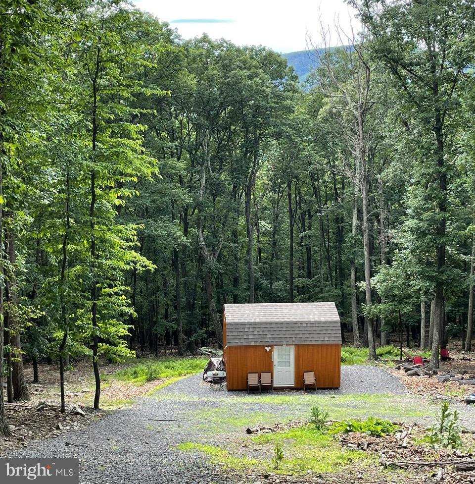 NATURE LOVERS LOOKING FOR A GREAT SAFE AND  SECLUDED  LOCATION OR TO LIVE OFF THE GRID, CALL TODAY TO SEE THIS 5.47 ACRES NESTLED IN THE MOUNTAINS OF HARDY COUNTY. THE SHELTER WAS BUILT IN 2020, IS 16x12 AND IS GREAT SHED  OR COULD BE USED FOR CAMPING. EVERYTHING CONVEYS  EXCEPT PERSONAL ITEMS, THERE IS A GENERATOR FOR HEATING AND COOLING AND A CAMPING TOILET.  IT HAS 2  LOFTS FOR SLEEPING/STORAGE. THE ACREAGE HAS LOTS OF TREES AND PLENTY OF WILDLIFE INCLUDING DEER AND TURKEY.  YOU ARE A SHORT COMMUTE OF 20 MINUTES TO THE AMENITIES IN MOOREFIELD INCLUDING WALMART, THEATRES,BANKING,SCHOOLS,AND RESTAURANTS.. THE DRIVEWAY IS ALREADY INSTALLED AND GRAVELED PLUS A SEPTIC PERMIT HAS BEEN ISSUED . MOVE TO WEST VIRGINIA AND BECOME A MOUNTAINEER.
Part of the driveway is encroaching onto Lot 28B and that owner has verbally agreed to the encroachment.