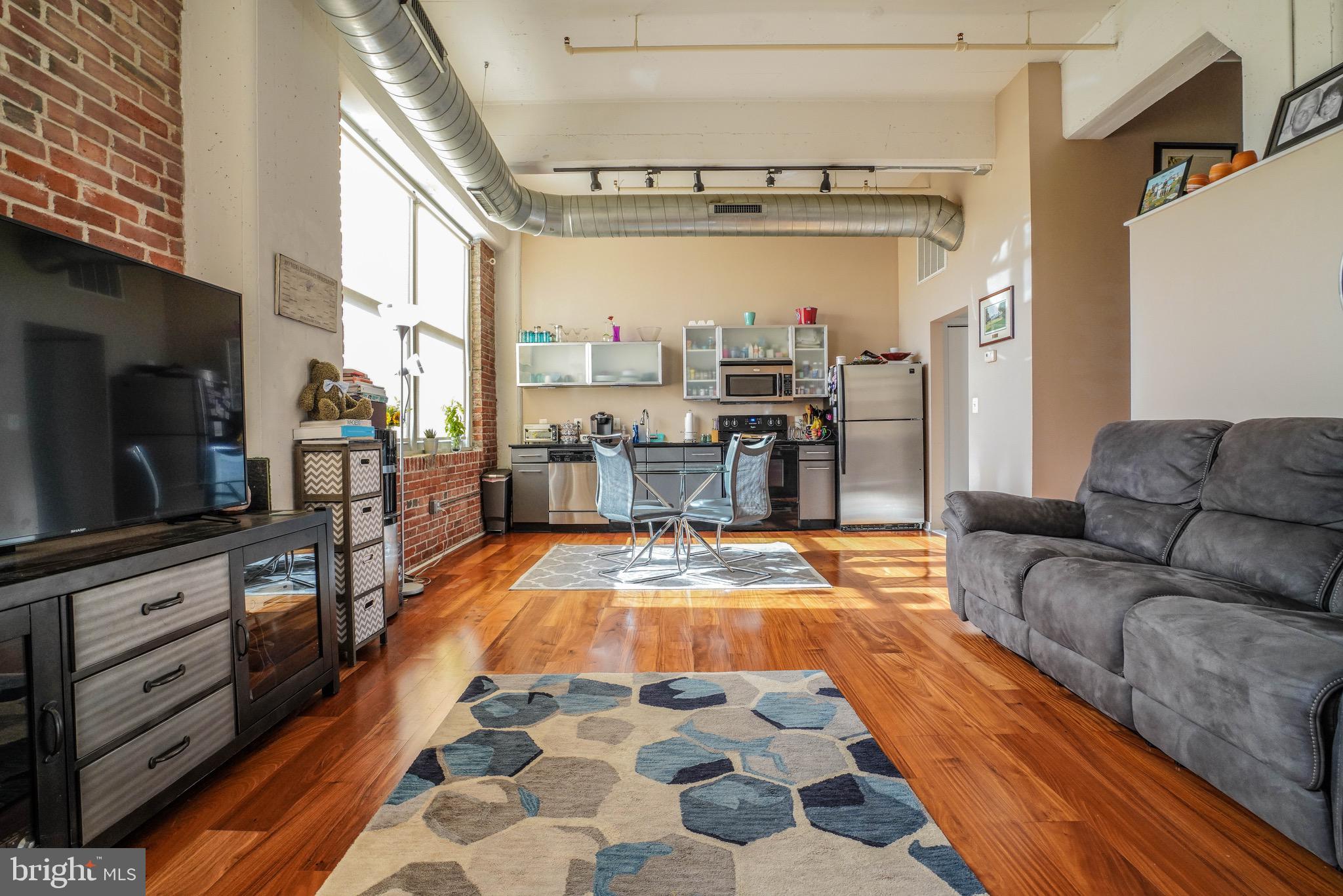 Loft living in the heart of Northern Liberties in downtown Philadelphia? YES, it's true. Here is your chance to own a bright and airy, move-in ready one bedroom condo. This corner unit such as #413 does not come around too often. Enter into a beautifully lit living room space with hardwood floors throughout and an industrial, rustic feel highlighted by the natural lighting. This open concept layout features a modern kitchen with a stainless steel appliance package with ranged, overhead microwave as well as plenty of cabinet space both above and below. Loop around the rest of this unit to see the full bathroom with ceramic vanity and underneath cabinet space, a shower/tub, and full master bedroom ready to be customized to your lifestyle. The Lofts at 444 offer the ideal location for the every day commuter(s) and on the go individual and/or couple. At the top of the amenity list are highlights such as one off street gated parking space,  24 hour concierge staff at the front desk, as well as a 8,000 square foot fitness facility with state-of-the-art equipment and machines and a storage unit unit for yourself and your belongings. Location is prime as this building has a tremendous walk score to some of Philadelphia's most sought after neighborhoods and nightlife and restaurants. Schedule your showing and see what the Lofts at 444 have in store for you!