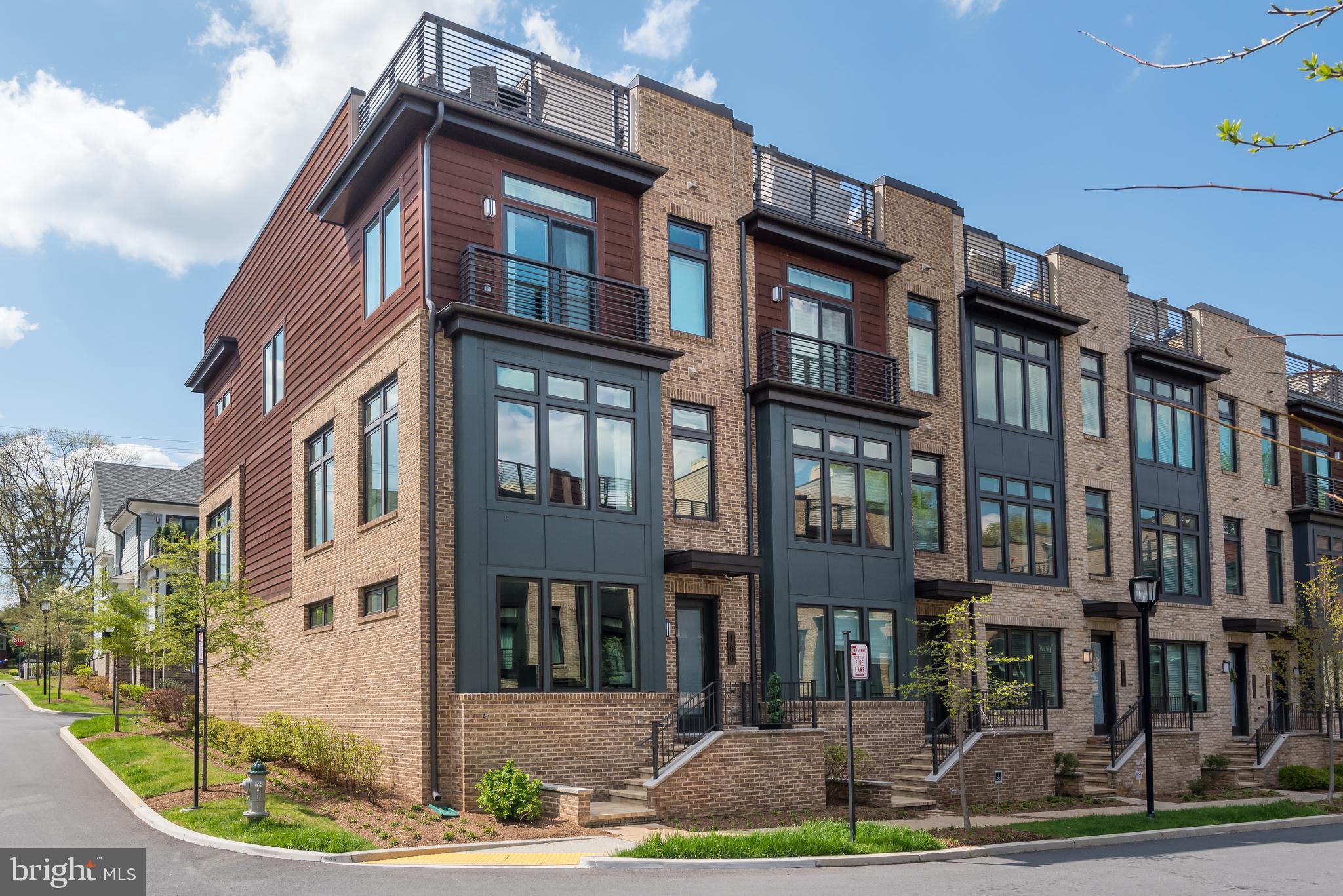 ****NEW PRICE FOR THIS BEAUTIFUL MODEL HOME!!!*** Have you been searching for a luxury townhouse that is situated in a great location?  If so, you are going to love this  4 Bedroom 3.5 Bathroom end unit contemporary elevator townhouse!  Welcome to Grosvenor Heights where Luxury converges with location in a tranquil 33-acre wooded community situated in what was part of the Grosvenor Estate.  Easily accessible to Wildwood Shopping Center, Grosvenor Strathmore Metro, Fleming Park, Rock Creek Park, Bethesda Trolley Trail and all major commuting routes being just minutes away!  The entry level has a comfortable multi-generational suite with a kitchenette having elevator access to all floors in the home including the expansive rooftop terrace. 10ft ceilings combined with floor to ceiling windows on the front, rear, and side of the main level provide an abundance of light that is uncommon in townhomes.  The modern kitchen is simply elegant having white quartz countertops with waterfall edges on the large island that seats 4.  Subway tile backsplash in a herringbone pattern, designer cabinets, pendant lights, an integrated subzero refrigerator topped off with stainless Bosch appliances. Relax by the gas fireplace in the family room that walks out to a large deck on the main level!  Meaning, outside dining near the kitchen without having to go to the rooftop! The bedroom level has the owner’s suite plus two large bedrooms along with another bathroom and a separate laundry room.  The sun filled owner’s suite has two closets and a spectacular ensuite bathroom. The expansive rooftop terrace is accessible from the elevator and features Brazilian hardwood deck tiles, retractable awning, large stainless kitchenette, Viking refrigerator, space for a TV, and a gas grill built into a stone veneer grill station with plenty of countertop space to use when cooking.  So many thoughtful choices were made with this Leed Certified home; Cedar Trim and brick to blend in with surrounding natural environment, Hardwoods throughout, custom chandelier, Sonos Sound System, Floor to ceiling drapes with custom edges, motorized window treatments, storage racks in the 2-car garage and much more.  WATCH 3D TOUR HERE -
