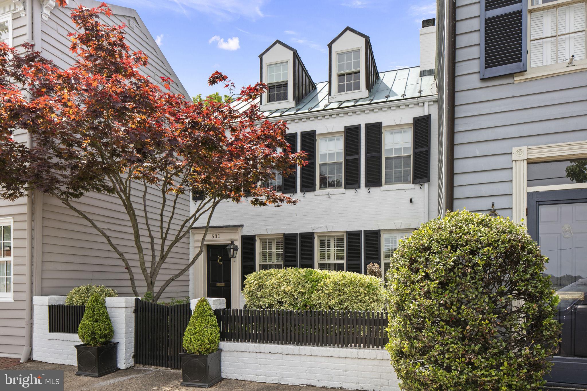 Quintessential Old Town in the heart of the desirable southeast quadrant overlooking Windmill Hill Park and the Potomac River. This special home, built in 1800, has been carefully and thoughtfully updated to retain the original character while allowing for today's comfort and conveniences. Step through the front gate and enjoy the spacious front patio with park and river views. Once entering the home, you are greeted by loads of charm. The front living room features an original fireplace, built-ins, dental crown molding, original hardware, arched doorways, and beautifully refinished hardwood floors throughout. The spacious dining room with Serena and Lily chandelier easily fits a table for six with access to the kitchen and the backyard. The kitchen is nicely appointed with inset cabinets, Viking gas range, heated stone flooring, and new farmhouse sink/faucet/cabinet hardware. At the rear of the home is a cozy sun room with a wall of windows and glass door overlooking back patio scene as well as a recently renovated powder room/laundry closet. The bedroom level features a spacious master with walk-in closet, beautiful wallpaper, custom window treatments including electric blackout shades, and views of the park and river. The full bath was recently renovated to include a new vanity, mirror, lighting, tile with heated floors, and steam shower. This level features two additional bedrooms, one with glass doors, fireplace, high ceiling, and extensive built-ins,  The bedroom level also features an additional full bath and multiple storage closets with beautiful original door hardware. The top level is a flexible space, ideal for bedroom, office, or playroom and features beautiful wood paneling and incredible river views. Quaint rear patio enhanced by brick walls, custom stone work, lighting, and fountain. Convenient rear gate entry off of back alley allows you to keep trash cans out of the way. Spacious cellar provides ample storage space for gardening tools, etc. This home offers everything an Old Town buyer could want including charm, updates and location. Come see what makes this home so special!