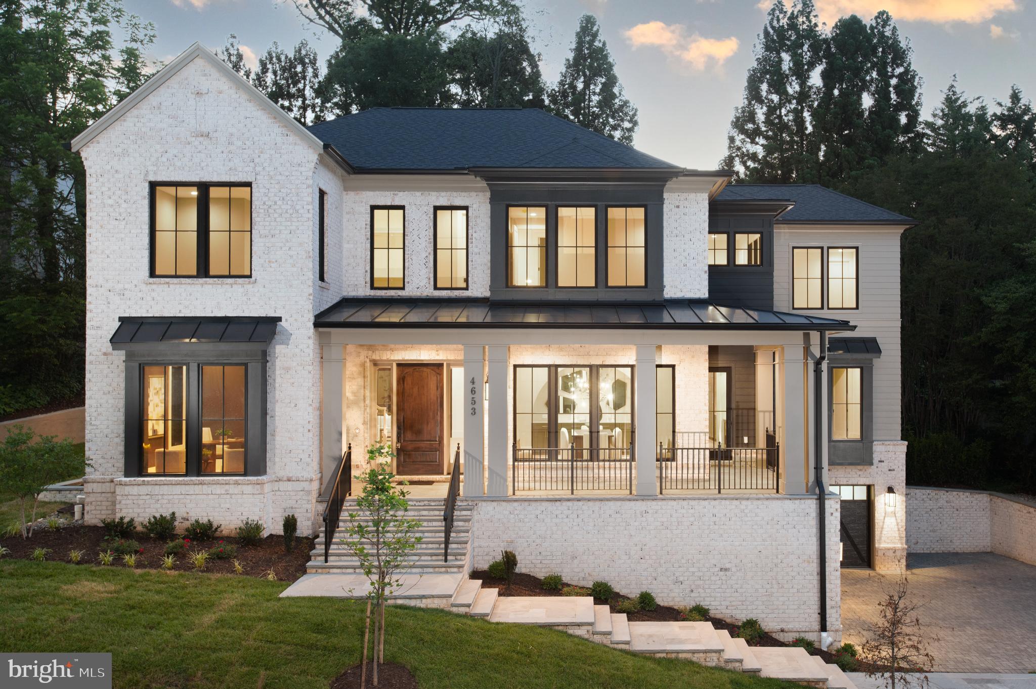 Now completed in Country Club Hills, Arlington’s premier neighborhood just minutes from Washington Golf & Country Club and Washington, DC, 4653 34th Street N represents a rare opportunity to own a new custom residence built by best-in-class design build firm, Classic Cottages.  Thoughtfully conceived for modern living, this 6-bedroom, 6-full bath and 2-half bath home offers the scale, quality, and quiet sophistication that discerning buyers spend years looking for — complete with a private elevator serving all three levels, a wraparound front porch, and a custom gunite plunge pool set within a beautifully landscaped .31-acre lot.

From the moment you step inside, the craftsmanship is unmistakable. Soaring 10-foot ceilings, 7.5in wide-plank white oak wood floors across every level, solid-core doors, extensive custom millwork and design detail, and a whole-home sound system establish an elevated and enduring standard of finish.  

The main level is ideally designed for daily living, special gatherings, or impromptu get togethers. A private office offers a quiet space to retreat and focus, while the dining room flows naturally into a fully equipped butler's pantry — with wine cooler, ice maker, and secondary dishwasher — and a hidden scullery that keeps the kitchen composed and organized no matter the occasion. The kitchen is exactly what serious cooks and gracious hosts demand: custom inset cabinetry, 3cm quartz countertops, a generous island, pot filler, and a Wolf and Sub-Zero appliance suite. The great room — anchored by a gas fireplace with stone surround — opens to a screened porch with integrated heaters, making the transition from inside to out completely natural. A main-level guest suite with walk-in closet and private bath ensures that visitors and family are accommodated with ease. 

Upstairs, the primary suite is a genuine sanctuary: two oversized walk-in closets, and a spa-caliber bath featuring dual vanities, a soaking tub, frameless glass shower, and heated tile floors. Three additional bedrooms each have a walk-in closet and en-suite bath access, while a loft sitting area and laundry room with storage and sink adds a layer of everyday comfort and functionality. 

The lower level is where the home quietly exceeds expectations. An entertainment room, wet bar with beverage center, full bedroom and bath, powder room, and a dedicated fitness room with traditional sauna offer the kind of lifestyle infrastructure that rarely comes standard — all connected by elevator, with walk-up access directly to the backyard and access to the 3-car garage. 

Outside, the setting is as refined as the interior. Flagstone pathways, terraced landscaping, and a custom 8' x 15' Gunite plunge pool with gas heater and automatic cover create an outdoor environment that is private, polished, and genuinely usable. The home's systems reflect the same forward thinking: dual-zone high-efficiency HVAC, whole-house steam humidification, solar-ready conduit, and EV charging are all in place. 

With easy access to the Chain Bridge,  GW Parkway, I-66, I-495, Reagan National Airport, and Arlington’s best parks and green corridors, this exceptional Country Club Hills home offers both new beginnings and a legacy address.