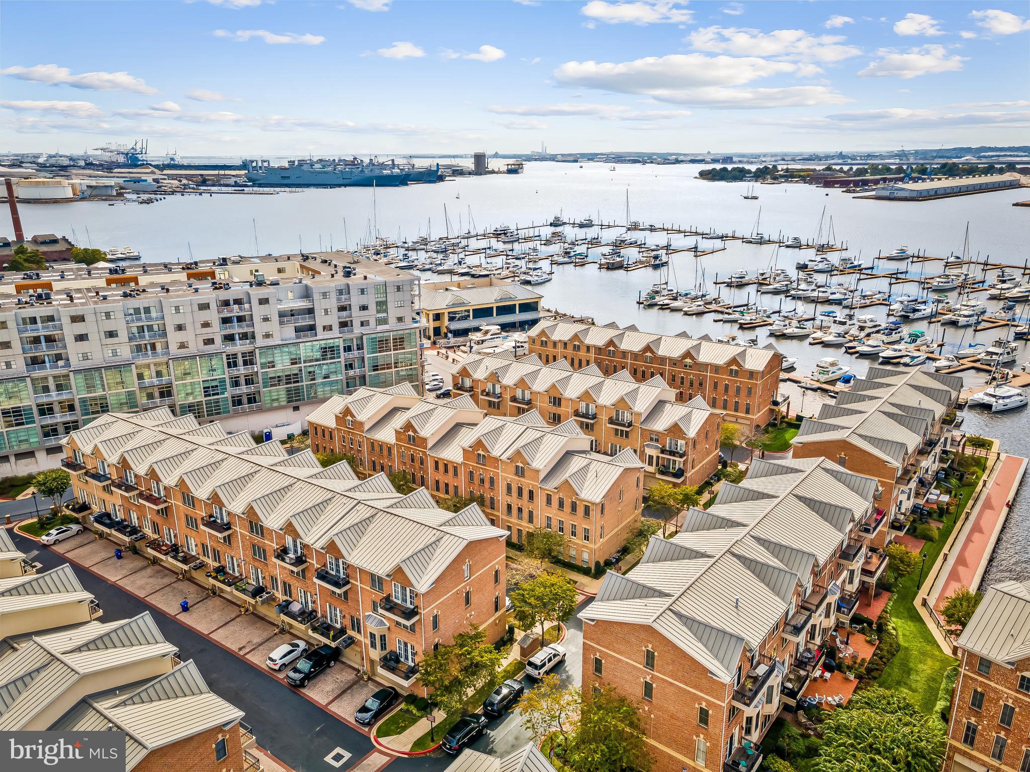 Welcome to 2618 Lighthouse Lane — an exceptional end-of-group, four-level waterfront townhome in the gated Moorings community of Canton, featuring the rare convenience of a two-car garage plus a two-car parking pad, all just steps from the waterfront promenade. Perfectly positioned where city living meets marina lifestyle, you can walk to top restaurants, boutique shopping, and a world-class marina right outside your door. Inside, hardwood floors flow throughout a thoughtfully designed layout anchored by a beautiful gourmet kitchen with high-end finishes that seamlessly open to a bright living area with water views and access to a private balcony—ideal for entertaining or enjoying the water views. The entry-level features a private bedroom and a full bath, perfect for guests or a home office. The second level offers a half bath, balcony, and an open-concept kitchen and living space filled with natural light and water views. The third level includes another bedroom, a full bath, and a spacious flex area that can easily serve as a family room, office, or be converted into a fourth bedroom. The entire top floor is dedicated to a luxurious primary suite, complete with a large bedroom, a private balcony with water views, an expansive walk-in closet, and a spa-inspired bath with a soaking tub and a separate shower. Surrounded by beautifully maintained landscaping and set within one of Canton’s most desirable gated communities, this home delivers the ideal blend of space, flexibility, and premier waterfront living.