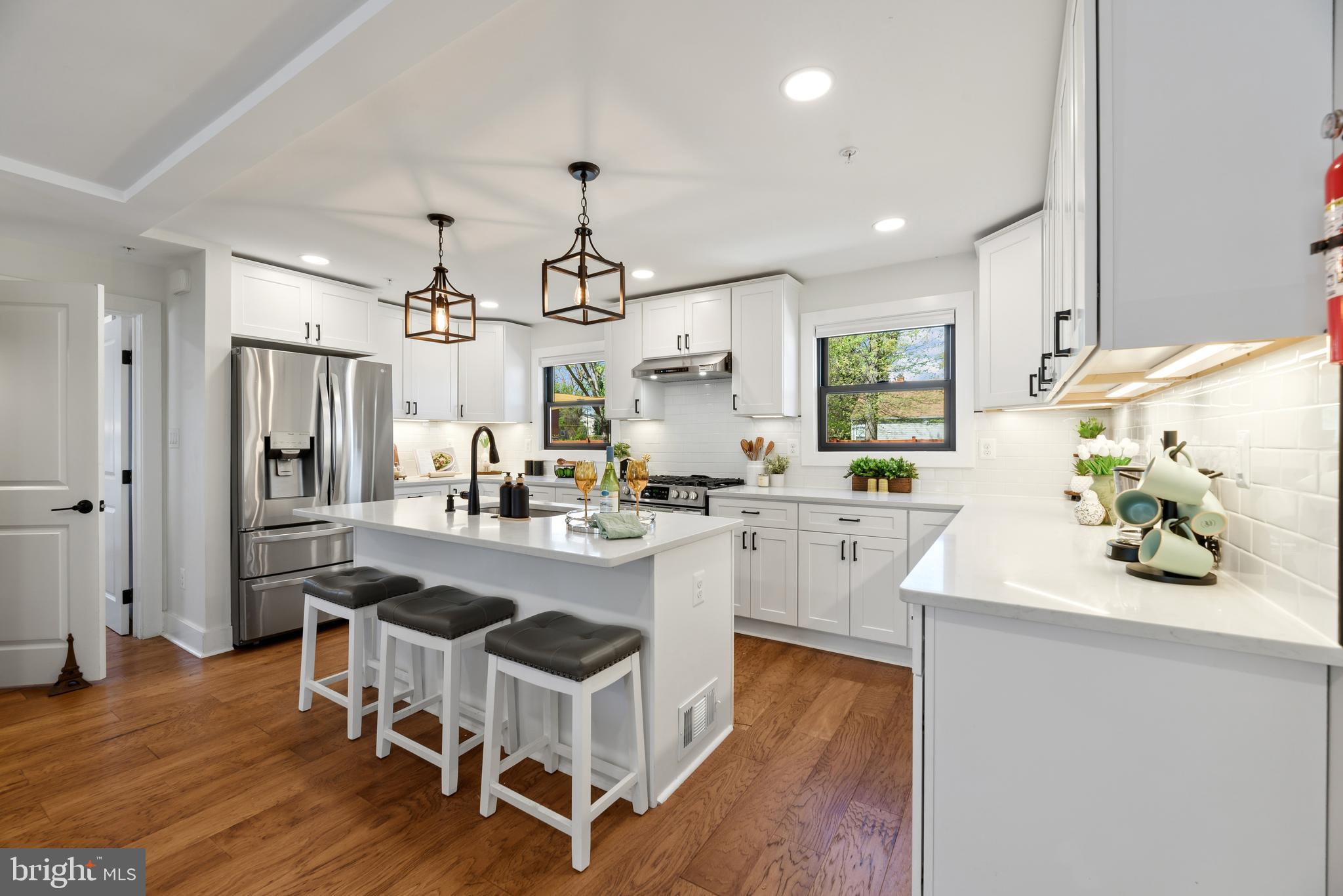 BEAUTIFULLY RENOVATED EASTPORT GEM with MODERN COASTAL FINISHES!  Perfect for a Primary Residence, 2nd Home or Rental Investment! ABOUT THE HOME:  3 levels of luxury living featuring 4 Bedrooms and 3.5 Bathrooms. Open-concept main level with New Hickory hardwood floors and designer lighting throughout.  THE GOURMET KITCHEN:  Custom white Shaker cabinetry, modern black hardware, Quartz countertops, oversized center island, and premium stainless appliances with gas cooking. THE PRIMARY SUITE:  A rare main-level primary retreat with walk-in closet and spa-like bath featuring custom tile work and glass-enclosed shower.  THE FLEXIBLE LOWER LEVEL:  Fully finished walk-up basement with a 4th bedroom/office, family room with wood accent wall, and a custom full bath—perfect for a guest or in-law suite.  THE EXTERIOR:  Iconic white picket fence in front, with cozy front porch, and a private rear yard with beautiful wood privacy fence is expanded by an additional 736 SF (included in sale). New Black Andersen 100 series windows, Hardie Plank siding, and new hardscaped paths.  PARKING:  Private driveway with 4 off-street parking spaces.  LOCATION:  Unbeatable walkability to Downtown Annapolis, Maritime activities, and local favorites.  See Annapolis City site for details on the Eastport Choice Neighborhood Initiative!  Enjoy all that Eastport has to Offer! Don't Let This One Get Away! Make your Appointment Today! 
Active Ring Camera on Property.