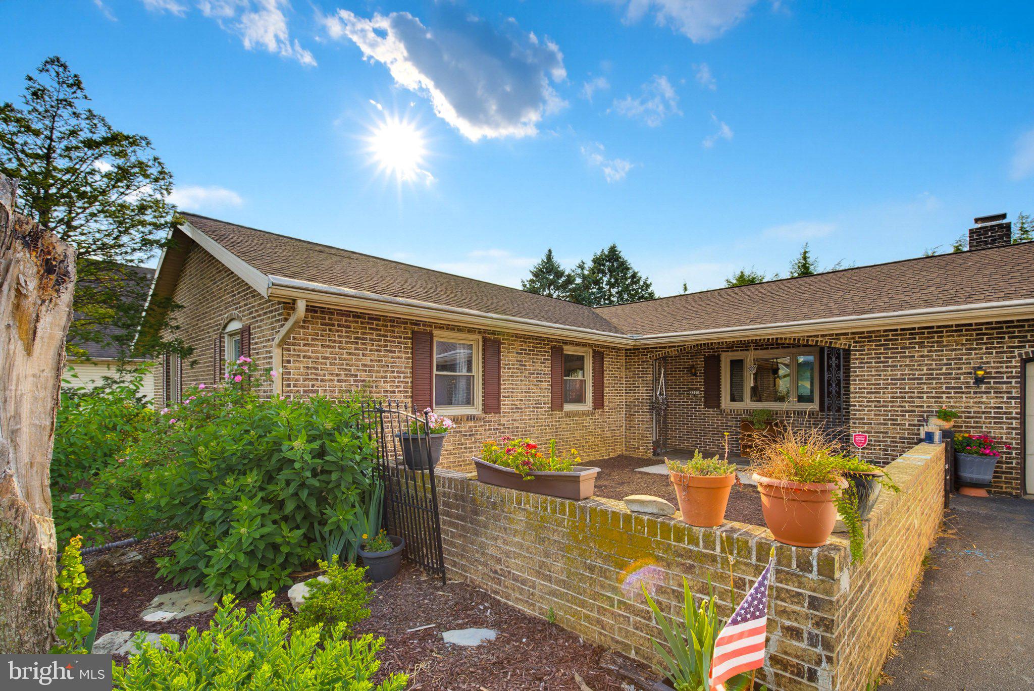 This solid brick ranch offers the convenience of one-story living with plenty of space and versatility. The home  features three bedrooms and three full bathrooms, providing a comfortable layout for everyday living.   A separate one-bedroom, one-bath in-law apartment offers flexibility for extended family, guests, or potential rental income.   The spacious lower level provides abundant storage or the opportunity to create additional living or recreational space. Outside, you'll enjoy a screened porch overlooking the property, as well as the convenience of a two-car attached garage.   With its functional layout, generous space, and endless possibilities, this home is full of potential and ready for your personal touch.