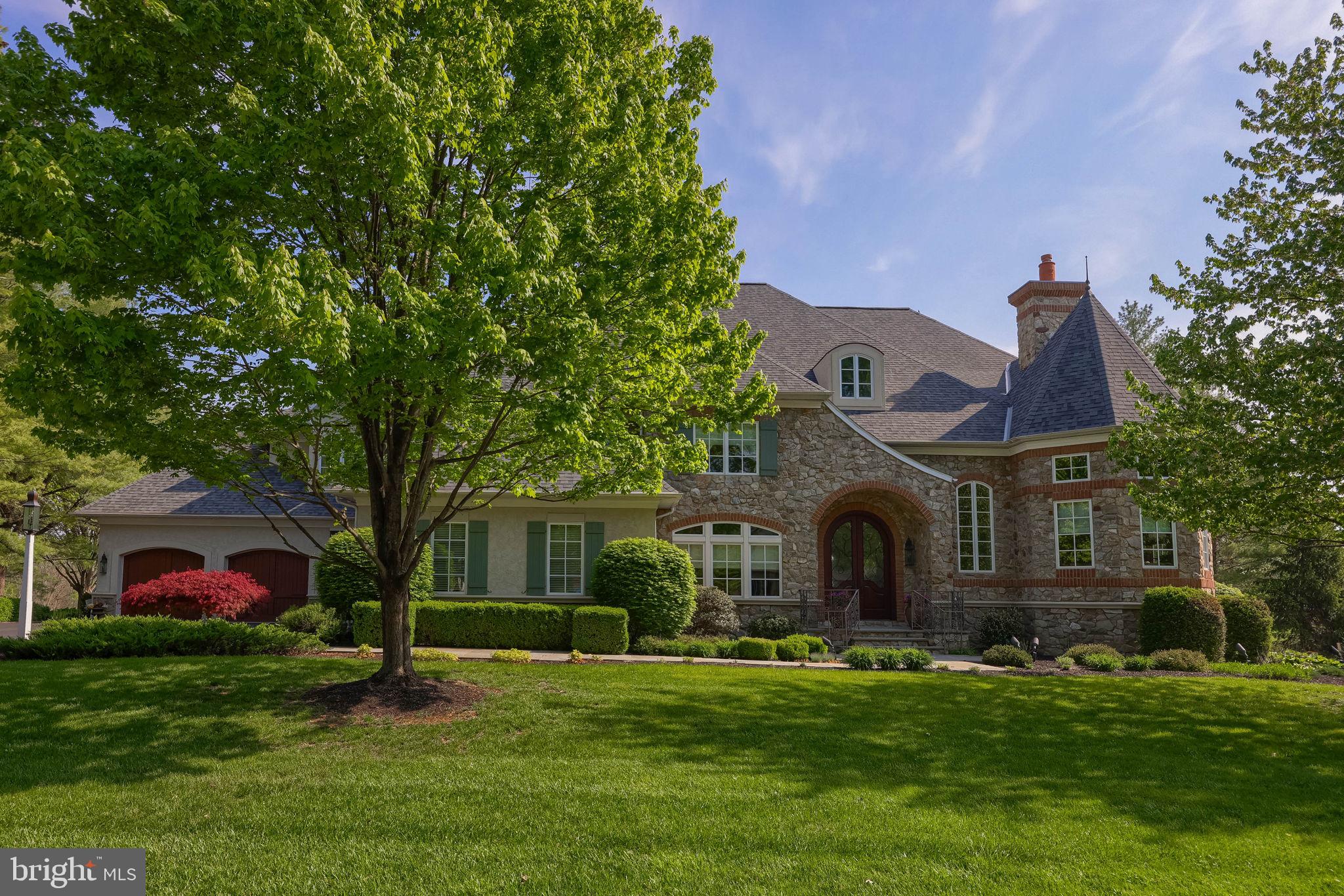 Nestled on a private cul-de-sac, this stunning French Country estate was custom built in 2006 on a one-acre lot overlooking the 5th and 6th holes of the Bent Creek Country Club Golf Course. With masonry stucco and stone construction, brick accents, and a new roof added in 2023, the home offers 8,605 square feet of total living space across three floors, including six bedrooms, with a possible seventh bedroom in the lower level, six and a half bathrooms, four fireplaces, and a four-car garage with basement access.

The two-story foyer welcomes you with marble flooring, a curved wrought-iron staircase, and a seven-foot crystal chandelier on a remote lift, while the family room features a coffered ceiling and a custom French 48-inch Rumford fireplace. The chef’s kitchen boasts custom cherry wood inset cabinets, granite countertops, limestone flooring, a Wolf double oven range, Sub-Zero refrigerator, two dishwashers (Miele and Fisher & Paykel), two custom islands, a walk-in pantry, and a large farmhouse sink. Additional main-level highlights include a private office with golf course views, a formal dining room with butler's pantry, a mudroom with built-in benches and a full bathroom, a library with floor to ceiling mahogany built-in bookshelves with rolling ladder & fireplace, a first-floor guest bedroom with a private full bath, a first-floor stackable washer and dryer, and a powder room with faux French-painted walls. 

Upstairs, the sprawling primary suite is a luxurious private retreat, complete with a cozy fireplace, a massive dressing room anchored by a large built-in cabinetry island with marble top, and custom-designed closets that offer exceptional organization and elegance. The second floor also includes a dedicated homework/computer room, a large laundry room with a long countertop and built-in cubbies for folding and sorting clothing, and additional bedrooms that each offer custom cabinetry, generous closets, and beautifully appointed bathrooms.

The lower level is designed for entertainment and wellness, featuring a gym with mirrored wall, game room, craft room with custom cabinetry and sink, a bar with granite countertops and dishwasher drawer, a family room with stone fireplace, a bedroom with full bath, and a home theater with elevated seating for twelve, plus a large unfinished storage area. From the mahogany and leaded glass front doors to the Rocky Mountain Bronze hardware and built-in sound and security systems, every detail of this property exudes timeless luxury.