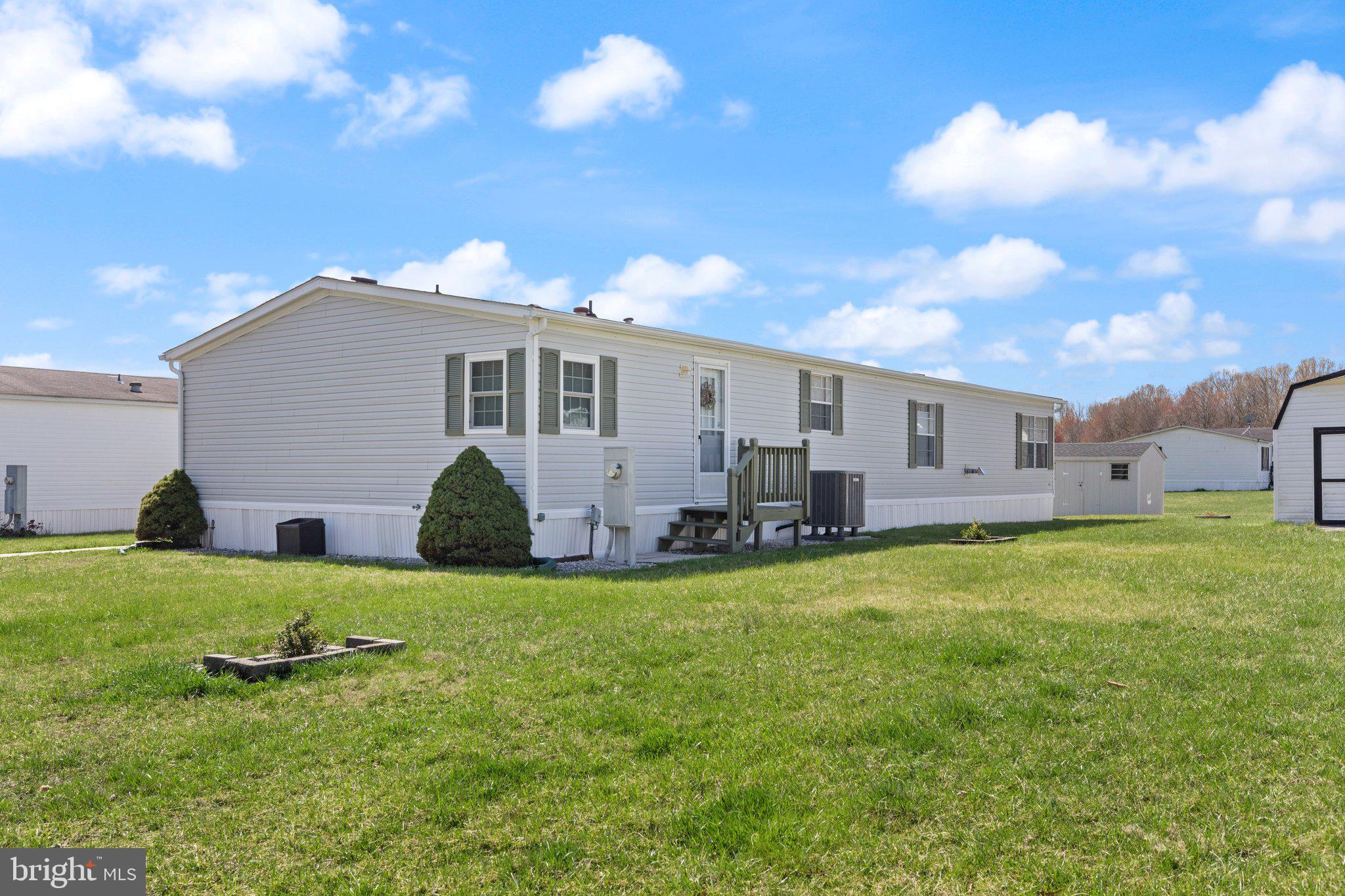 Welcome to this beautifully upgraded and spacious double wide mobile home offering 1,848 square feet of comfort and charm. This 3-bedroom, 2-bath home is warm, inviting, and move-in ready, featuring newer carpet, crown molding, chair rail throughout, and all new lighting and fixtures. The stunning kitchen includes 42” upgraded white cabinets, stainless steel appliances, beveled edge countertops with seating, and plenty of cabinet  and counter space. Enjoy a cozy electric fireplace in the living area, five ceiling fans for year-round comfort, a large laundry/mudroom, and an upgraded master bath along with an updated second full bath. Unique to this home are its three separate exit doors—front, side, and rear—all with screen doors. Concrete sidewalk access, offering convenience and flexibility. Additional highlights include a new Lennox HVAC system (inside and out)and a shed with a new roof, exterior upgrades, and built-in shelving. A 2-car parking pad adds off-street convenience, completing this well-maintained and thoughtfully enhanced property. Don’t miss your chance to own a home that truly stands out from the rest—schedule your tour today!