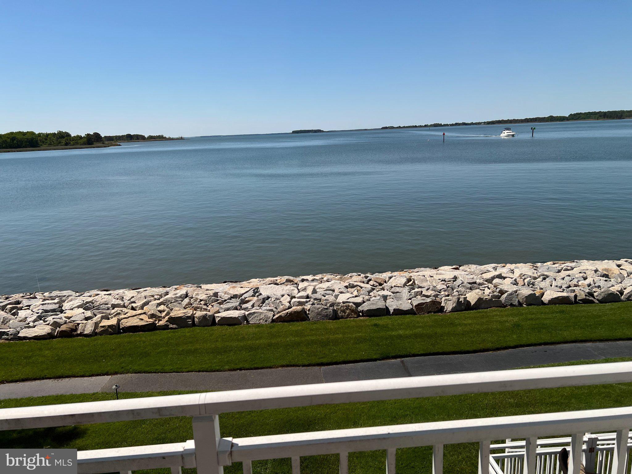 Welcome to this sought-after WATERFRONT END townhouse with SPECTACULAR PANORAMIC VIEW! This southern exposure is ideal for watching the boats head toward St. Michaels, Oxford & Annapolis.  Oyster Cove  is a gated community and is a perfect place for your home office.  Nothing soothes the soul  like looking at gorgeous, blue water.  Enjoy the outdoors from any of your 3 decks - front, rear & primary suite.  OPEN FLOOR PLAN with fresh paint throughout.  First floor offers hardwood floors and full bath! !   Kitchen has Corian counters, window seat, backsplash, ss appliances, convection oven, breakfast bar, large refrigerator with freezer drawer at bottom and TV to enjoy while preparing your favorite dishes for your family and friends.  LR has gas FP and spacious deck with retractable awning and gate.  Bonus room on first floor - entertainment center with large TV could be used for an  office/den/bedroom.   2nd floor has LVP flooring, laundry room, guest bath and a primary suite offering waterfront deck,  large W-I closet, jacuzzi, W-I shower & spacious vanity.  The second and third bedrooms have water views and  wonderful light.  Third floor loft has a great water view,  carpet and may serve as a  2nd primary suite with bath for guests/den/office and wonderful storage space.!   4 FULL BATHS!   Furniture on both decks included if desired .  WARRANTY.    Beautiful clubhouse has new furniture, gym w/TV, kitchen for socials & rental occasions.  Monthly get togethers & holiday parties are an opportunity to meet your neighbors.  Take in the morning sun on the 1.5 mile waterside walking path.  Also there are 2 marinas (1 in protected, deep water) with 100+   35'-60' slips available to rent/buy.  Take a dip in the salt-water pool, rent 1 of the 6 jet ski docks or play a game of tennis/pickleball.  Storage is available  for > 100 kayaks.  Walk to 5 restaurants!  Near 38-mile Cross Island Trail - great for biking, jogging, dog walking, etc.  Pet-friendly community - check with HOA on breed restrictions.   Only 20 minutes to Annapolis.  Change your address & change your LIFESTYLE!