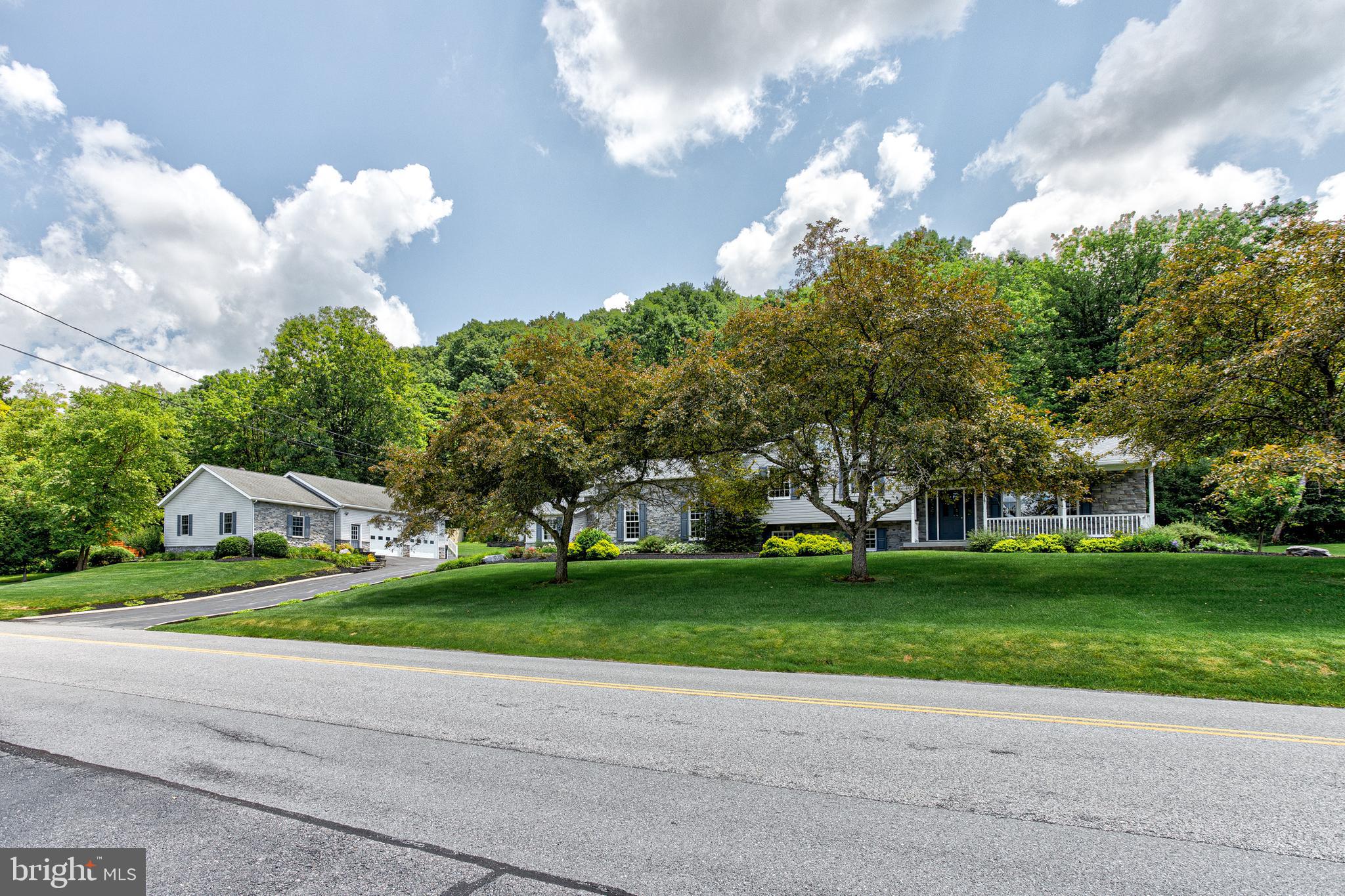 Set on a peaceful stretch of countryside, 443 Stevenson Road offers the perfect blend of privacy and convenience. This well‑maintained home sits on a generous lot surrounded by mature trees and open views, creating a serene retreat ideal for anyone seeking space without sacrificing proximity to town. 
Inside, you’ll find a warm and inviting layout with bright natural light. Flexibility for family and guests with spacious living areas which include a living room, huge great room and rec room. Three fireplaces, one in the primary bedroom suite. Large office with built in desks and filing cabinets. Brand new appliances in the eat-in kitchen. Two heat pumps for cooling and heating. Step outside to a separate garage featuring 2 bays with workbenches and storage units, a half bath and a heated room currently used a s a gym. 
With easy access to State College, Penn State, parks, trails, and major commuter routes, 443 Stevenson Road combines rural tranquility with everyday convenience. A wonderful opportunity to own a home that offers both comfort and room to grow.