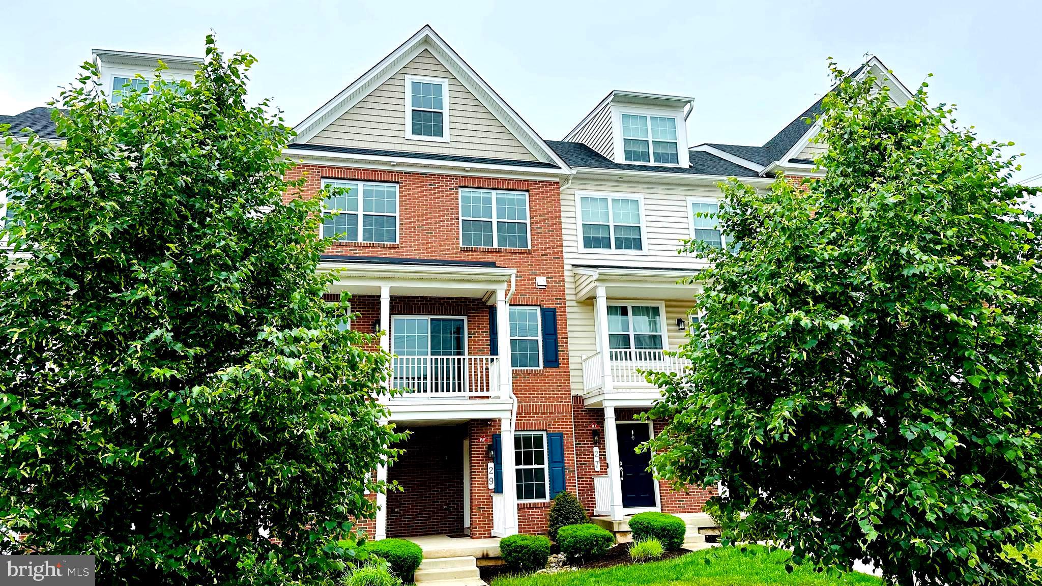 Beautiful newer construction townhome located in the highly desirable Penn Square community in Lansdale Borough, built by WB Homes in 2019.  This well-maintained home offers modern living with style and comfort. Featuring approximately 2,000 square feet of living space, this spacious home includes a attached two-car garage with additional storage and rear parking. The attractive exterior combines brick and vinyl siding and is highlighted by a large second-floor balcony. Positioned in the center of a charming row of townhomes, the property offers both curb appeal and functionality. Inside, the main living level features 9-foot ceilings, luxury vinyl plank flooring, and an open-concept design ideal for everyday living and entertaining. The gourmet kitchen is equipped with GE and KitchenAid appliances, a stunning glass tile backsplash, ample cabinetry, and modern finishes throughout. The adjoining dining and living areas create a bright and welcoming atmosphere, complemented by a convenient powder room. The upper level includes a spacious primary suite with a private bath, an additional bedroom with its own full bathroom, and a stackable Electrolux washer and dryer. The top floor offers a large third bedroom and another full bathroom, providing flexible space for guests, a home office, or additional living needs. Additional features include upgraded appliances, plush carpeting on upper levels, abundant closet and storage space, window treatments, and newer mechanical and electrical systems.  This move-in ready home is located in a wonderful community and offers low-maintenance living with all the modern conveniences buyers are looking for. Conveniently situated close to North Penn schools, shopping, restaurants, parks, and major commuter routes. Welcome!