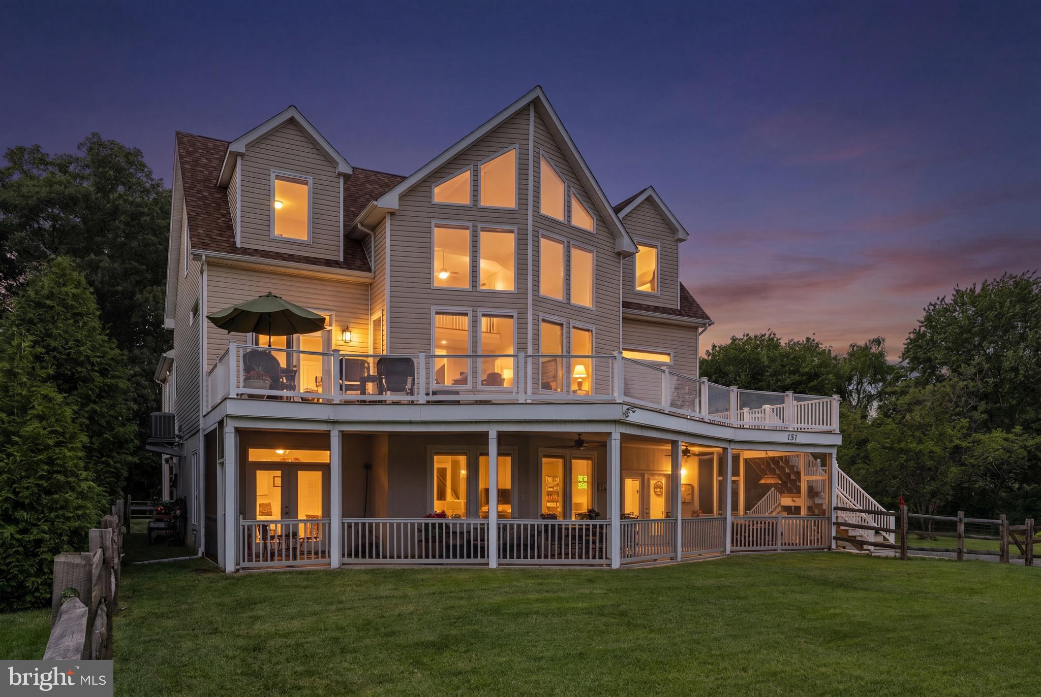 Welcome to your dream riverfront-adjacent retreat in the highly desirable Ches Haven community of Earlville! Situated just 200 feet from the Sassafras River, this exceptional detached home offers an unparalleled coastal lifestyle, complete with exclusive access to a private community boat ramp. From the fresh exterior doors to the thoughtful designer updates throughout, every inch of this property has been curated for comfort, luxury, and effortless entertaining. The main level serves as the heart of the home, anchored by a dramatic two-story living room. Here, floor-to-ceiling windows frame breathtaking, unobstructed sunset and river views, while a newly installed gas fireplace with a magnificent floor-to-ceiling limestone surround creates a striking focal point. Culinary enthusiasts will fall in love with the gourmet kitchen, which boasts high-end Viking appliances, along with a freshly updated backsplash and modern light fixtures. Retreat to the main-floor primary bedroom suite, featuring a beautifully updated en-suite bathroom. This level also includes a bright sunroom and a spacious wrap-around deck—complete with water and propane hookups—making it the ultimate spot for alfresco dining against a waterfront backdrop. The clever layout offers maximum privacy for family and guests alike. Upstairs, you will find a versatile loft space perfect for a home office or reading nook, alongside two generously sized bedrooms, each featuring its own private en-suite bathroom. The lower level is equally impressive and serves as an ideal guest quarters or recreation hub. It hosts a cozy family room, a guest bedroom, a full bathroom, and a seamless transition to a massive screened porch where you can relax and soak in the river views. Outdoor living is a breeze with two distinct fenced yards. The fenced front yard pairs perfectly with the lower-level screened porch, which also features a convenient outdoor shower for rinsing off after a day on the river. The fenced rear yard offers privacy and houses a separate one-car detached garage, supplementing the one-car attached garage on the lower level. Peace of mind comes standard with major recent updates, including a two-year-old furnace and a two-year-old water pump. This Earlville gem perfectly blends modern luxury with relaxed river-life charm—schedule your tour today and start living the Ches Haven lifestyle!