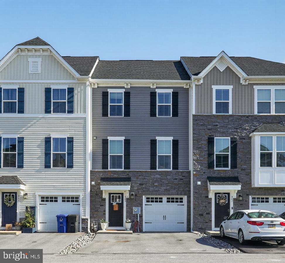 *Open House on Saturday, July 11th & Sunday, July 12th 12-2PM!* 
Welcome to 265 Sugar Maple Square. This lovely, like-new townhome in the Downingtown Area School District is a must see. As you enter the home, notice the expansive 1st floor living area that includes a coat closet, powder room, utility closet with additional storage and a finished recreation room with durable vinyl tile flooring. Walk outside through the glass sliding doors to enjoy the quaint backyard. As you walk upstairs, you are welcomed by open-concept main floor living, with a spacious dining area and eat-in kitchen. Enjoy meals with family and friends at the expansive kitchen island with granite countertops. The kitchen includes modern white cabinetry, stainless steel appliances, a gas oven/range, and a spacious pantry. Make your way into the living room that is complete with a powder room attached. Enjoy the beautiful spring weather on your private, full-size deck complete with Trex material and white railings. On the 3rd floor, find three bedrooms and convenient 3rd-floor laundry. The owner's suite offers a grand bedroom, walk-in closet, dual-sink vanity and a glass walk-in shower. Two additional bedrooms are paired with an additional full bathroom with soaking tub. An attached 1-car garage provides additional parking and storage opportunities. Rest easy with an outdoor Ring security camera. Upgrades throughout the home include luxury vinyl plank flooring in the entryway, 2nd floor and 3rd floor, 1st floor powder room addition, vinyl tile basement (2022), upgraded white cabinetry in the kitchen and 3rd floor bathrooms, outdoor vented range hood, full size Trex deck, a high-efficiency HVAC system with Nest thermostat, recessed lighting, a custom basement door (2024) and new stair carpeting (2026). Enjoy the private but convenient location, just a short drive from the Downingtown or West Chester Boroughs, Whole Foods Market in Exton or the King of Prussia Mall. Schedule your appointment today!