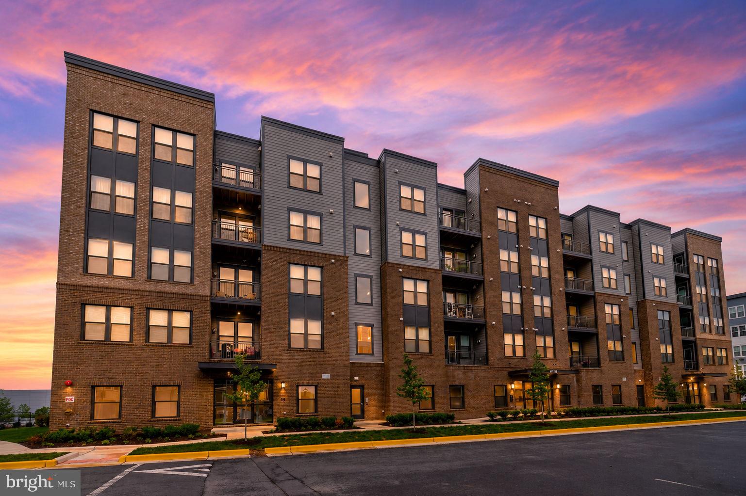 Experience upscale, low-maintenance living in this nearly brand-new condo at The Residence at Waxpool Crossing — ideally located just a mile from the Silver Line Metro, major commuter routes, shopping, dining, and everything Ashburn has to offer. Built in 2024 and delivered in 2025, this beautifully designed residence offers the benefits of nearly brand-new construction without the wait, delays, or builder premiums. Located on the 4th floor of a 5-story building, this 2-bedroom, 2-bath condo with a versatile den/office features a bright open-concept layout filled with natural light, creating the perfect balance of comfort, style, and functionality. The modern kitchen opens seamlessly to the spacious living and dining areas, making everyday living and entertaining effortless. The flexible den provides the ideal space for a home office, separate dining room, or workout room — perfect for today’s lifestyle.
The spacious primary suite offers a peaceful retreat with a large walk-in closet and a beautifully appointed en-suite bath. Enjoy the convenience of in-unit washer and dryer, elevator access, secure building entry, garage parking space #16, a large storage bin #9, and a true lock-and-leave lifestyle in one of Ashburn’s most desirable locations. Relax on your private balcony, enjoy easy access to the Metro, and take advantage of nearby parks, trails, restaurants, and retail just moments from your door. Rare opportunity to own one of the community’s most desirable floor plans, priced under $500K in the heart of Ashburn. Move-in ready and beautifully maintained — schedule your showing today!
