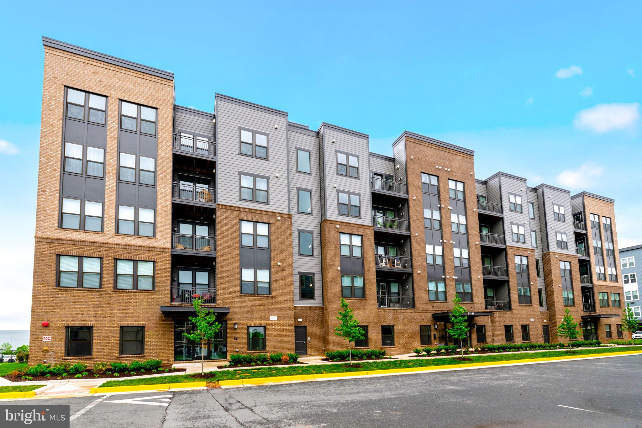 Experience upscale, low-maintenance living in this nearly brand-new condominium at The Residence at Waxpool Crossing — ideally located just a mile from the Silver Line Metro, major commuter routes, shopping, dining, and everything Ashburn has to offer. Built in 2024 and delivered in 2025, this beautifully designed residence offers the benefits of nearly brand-new construction without the wait, delays, or builder premiums, and the seller is willing to help the buyer with closing costs! Located on the 4th floor of a 5-story building, this 2-bedroom, 2-bath condo with a versatile den/office features a bright open-concept layout filled with natural light, creating the perfect balance of comfort, style, and functionality. The modern kitchen opens seamlessly to the spacious living and dining areas, making everyday living and entertaining effortless. The flexible den provides the ideal space for a home office, separate dining room, or workout room — perfect for today’s lifestyle.
The spacious primary suite offers a peaceful retreat with a large walk-in closet and a beautifully appointed en-suite bath. Enjoy the convenience of in-unit washer and dryer, elevator access, secure building entry, garage parking space (#16), a large storage bin (#9), and a true lock-and-leave lifestyle in one of Ashburn’s most desirable locations. Relax on your private balcony, enjoy easy access to the Metro, and take advantage of nearby parks, trails, restaurants, and retail just moments from your door. Rare opportunity to own one of the community’s most desirable floor plans, priced under $500K in the heart of Ashburn. Move-in ready and beautifully maintained — schedule your showing today!