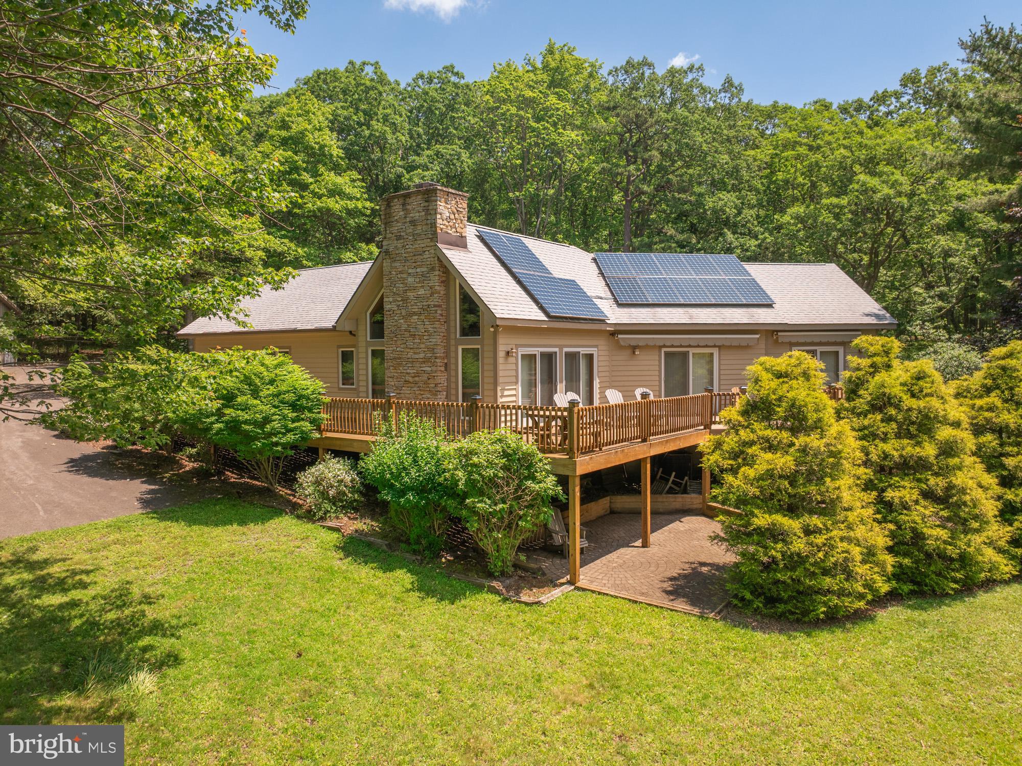 Discover the best of Deep Creek Lake living on a sprawling 276’ of waterfront in the highly sought after Turkey Neck loop. This contemporary home is situated nicely on 2.61 acres and is just steps from your private Type A dock. It feels very private from the moment you pull onto the paved driveway. Inside this thoughtfully designed single-level home you will find a spacious great room with vaulted ceilings, fireplace, and an open kitchen/dining/living area create a perfect gathering space. Boasting 4 bedrooms (two of which are en suites), 3 bathrooms, an open floorplan, hardwood floors and a main level laundry room. Step outside any of the multiple sliding doors to your expansive lakeside deck—ideal for sunsets, entertaining, or quiet summer mornings. Offering lake views from almost every room. The detached oversized garage is perfect for boat and toy storage. The buydown has been purchased, as well as a membership to the Loop Association which affords you access to 28.77 acres. Easy access to the Deep Creek Yacht Club. Call today to preview!