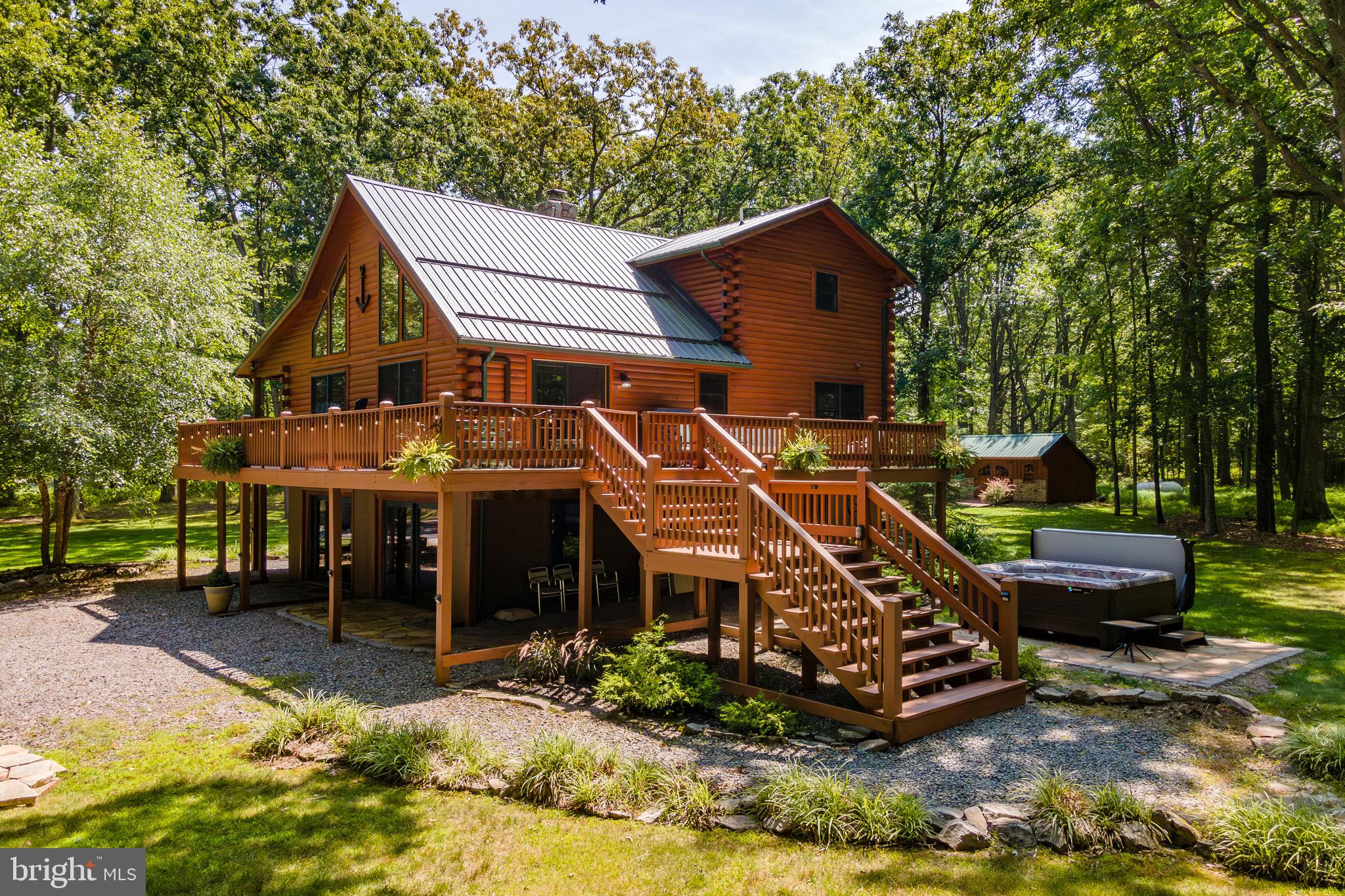 Private Lake Access Log Home at Deep Creek Lake – Nestled on almost three acres of wooded land, this 4Bed 3Bath Lodge is located just past Thousand Acres Golf Course and features a mix of rustic and modern asthenic that’s open and bright with vaulted ceilings and plenty of glass to bring in the natural beauty and abundant light. Several recent facelifts including interior paint, furniture and flooring on the lower level. Enormous wrap around deck with seasonal lake views. Homely wood burning fireplace. Contemporary kitchens and bathrooms. Fully finished walk-out basement providing ample space for lounging or a game of pool. Private Hot Tub, Outdoor firepit… plus you’re right across the street from your very own dock slip on some of the nicest lake access at Deep Creek! If you’re looking for a rustic mountain lake getaway, offering privacy that few lake homes can provide… call today to learn more!