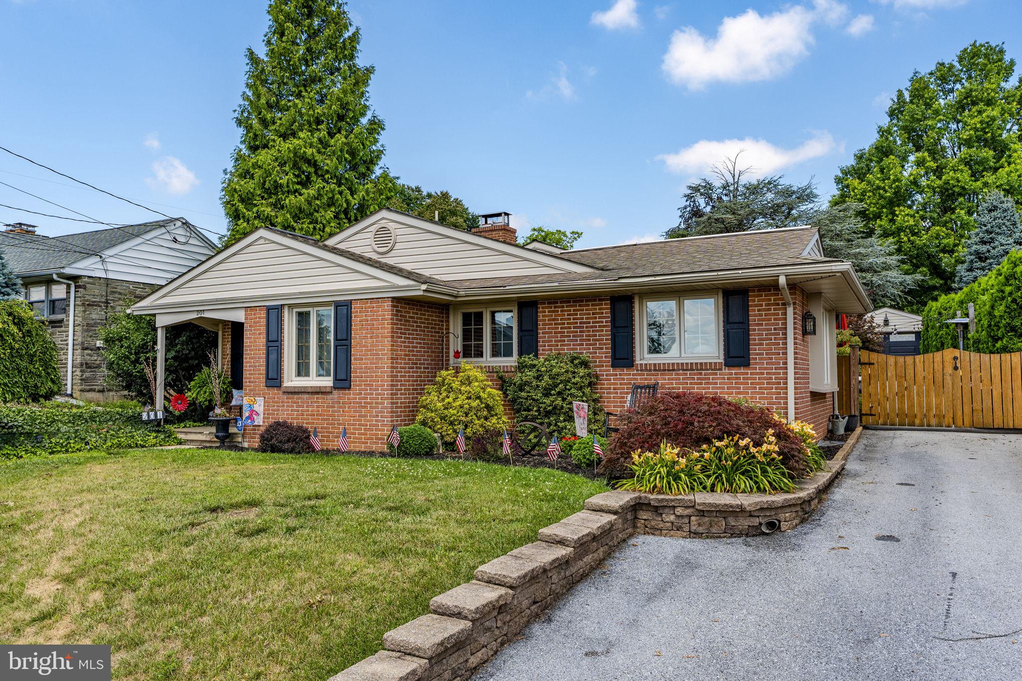 Welcome to this charming brick home nestled in the town of New Holland, where timeless character meets thoughtful updates. Warm bamboo floor welcomes you into the spacious living room, creating an inviting space to relax or entertain. The beautifully appointed kitchen features granite countertops, stainless steel appliances, a five-burner gas cooktop, an open-beam ceiling, and a convenient breakfast bar. The bright and cheerful dining area boasts hardwood flooring, a triple window that fills the space with natural light, and a sliding glass door leading to the outdoor patio for seamless indoor-outdoor living. The house offers 3 bdrms up three steps from the main living area wall with hardwood flooring. One full bath on bdrm level and one full bath on the main level. The finished lower level expands the living space to 2378 SF, including a cozy family room highlighted by a wood-burning fireplace plus a 4th bdrm with a closet-ideal for guests, a home office, or additional living flexibility. Enjoy year-round comfort with energy-efficient natural gas heat and central air. Outside, the private, fenced backyard is designed for entertaining and relaxation, featuring two spacious brick paver patios mature landscaping, and a power-operated gate for added convenience. A detached one-car brick garage completes this exceptional property. Located in desirable New Holland Borough, this move-in ready home offers comfort, charm, and inviting indoor and outdoor living spaces. Don't miss the opportunity to buy this lovely house/property!