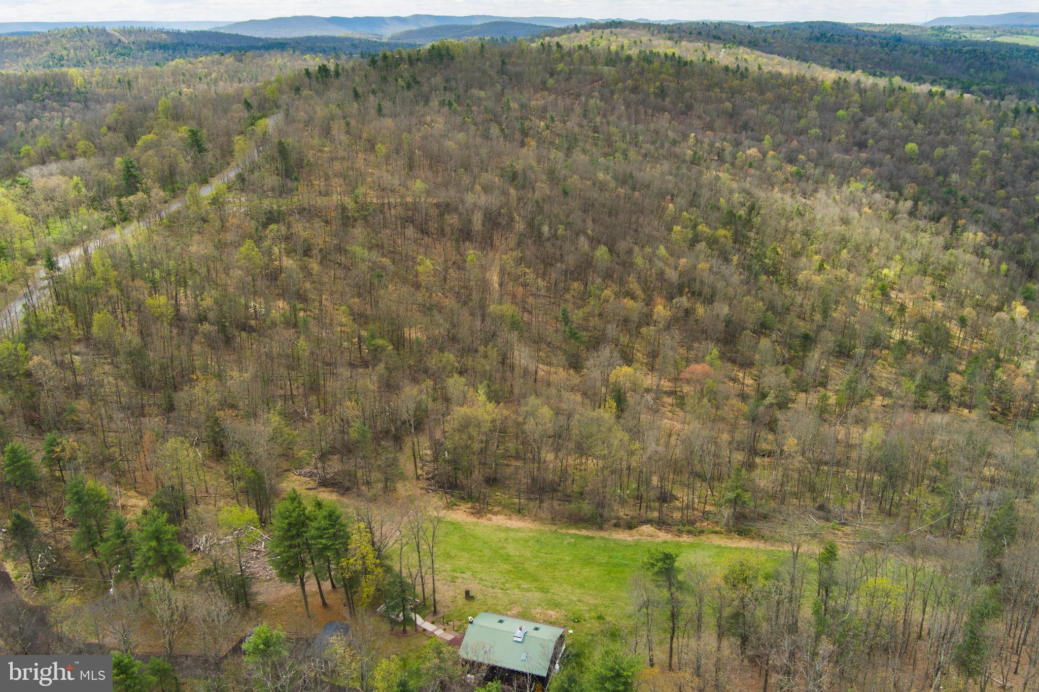Taylors Woods. Conveying mineral rights and 190 acres in Howard, Pennsylvania, situated within five minutes of Pennsylvania State Game Lands 92 and the Sproul State Forest boundary — with Bald Eagle State Park less than ten minutes away. Together these public lands and recreational resources place Taylors Woods at the center of one of the most accessible outdoor corridors in Central Pennsylvania. Bald Eagle State Park's reservoir offers bass, pike, and muskie fishing, while Bald Eagle Creek — a Class B trout stream — feeds directly into it. State Game Lands 92 and Sproul State Forest provide thousands of acres of huntable public ground within a short drive of the cabin.

The forest at Taylors Woods has been evaluated by Calvin Norman, CCF, TSP, Audubon Certified Forester with Blue Ox Nursery & Forestry. The property contains four distinct habitat types. The upper ridge is dominated by chestnut oak, white oak, and hickory — recently opened by harvest, now developing early-successional browse and native understory including blueberry, wild rose, and teaberry. The lower slope transitions into a red maple stand dense enough to support a small-scale maple syrup operation. Two hemlock stands — one on the north end and one in the southern section — provide thermal bedding cover that concentrates deer on the property through winter. Vernal streams run through the land toward the adjacent Little Marsh Creek corridor, creating a wildlife travel funnel that draws deer, turkey, and other game onto the property to bed and feed.

Multiple log landings are distributed throughout the 190 acres — cleared, ATV-accessible openings that are natural food plot development sites requiring minimal investment. Existing tree stands are in place. A formal deer management program can be established through landowner tags or enrollment in Pennsylvania's Deer Management Assistance Program. Forest management practices including water bar installation, native seeding, and regeneration protection are eligible for cost-share funding through NRCS EQIP/CSP — the PA Woodland Resilience Enhancement Network can fund up to $25,000 in qualifying improvements.

A named trail network runs throughout the property, accessible by ATV or foot, connecting the upper ridge to the lower slope stands and reaching every major habitat feature on the 190 acres.
The 1,800 square foot cabin is renovated and move-in ready. Vaulted wood ceilings, skylights, stone fireplace, granite countertops, main-floor bedroom, full bath, half bath, and loft. Metal roof, 200+ amp service, well, septic, propane, wood stove, and ductless mini-split. Appliances and washer/dryer included. Outdoor fire pit, storage shed, and room to add a garage, pole barn, or additional structure.

Minutes from I-80. Approximately 30 minutes to State College and Penn State. Reachable from Philadelphia, Pittsburgh, New York, New Jersey, Baltimore, and Washington in a day's drive.