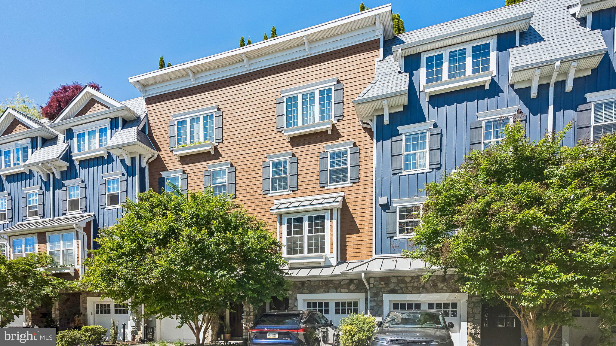 Like-new and completely turnkey, this exceptional townhome offers sophisticated design, luxurious finishes, and multiple outdoor living spaces in one of Manayunk’s most desirable locations. Thoughtfully upgraded throughout, the home features engineered hardwood floors; recessed lighting; a full house Sonos system; custom millwork; automated blinds in the primary bedroom, living room and study; designer wall coverings; and striking architectural details including coffered and coved ceilings. Additionally there is a whole house water filter with bypass and a geo-thermal HVAC system.
The main living level is designed for both everyday living and entertaining, featuring a spacious open-concept layout with a gourmet kitchen, dining room, and living room. The chef’s kitchen boasts quartz countertops, White Shaker cabinetry, a large center island, double-door pantry, GE Café and Monogram appliances, a six-burner gas cooktop, double wall ovens, and an EdgeStar beverage refrigerator. The dining room is enhanced by a custom built-in buffet with two Alla Vino wine and beverage refrigerators, while the living room offers custom shelving, a remote-controlled gas fireplace, and access to a private balcony.
The luxurious primary suite occupies its own private level and features two custom walk-in closets, a remote-controlled gas fireplace, and a spa-inspired bathroom with double-door entry, a frameless glass shower with marble and porcelain tile, double vanity with quartz countertop, freestanding soaking tub, private water closet, and large linen closet.
The level below includes two generously sized bedroom suites, each with custom outfitted closets and private en-suite bathrooms. A spacious laundry room with oversized LG side-by-side washer and dryer, utility sink, and abundant storage completes the floor.
The entry level offers exceptional flexibility with a private study featuring patio access, a full bathroom, custom-built coat closet, and direct access to the attached one-car garage. A dramatic board-and-batten staircase and foyer create an impressive first impression upon entry.
Crowning the home is an incredible green roof deck spanning the full length of the house featuring AstroTurf-covered entertaining areas, a covered lounge space with television, and sweeping views perfect for relaxing or hosting guests.
A rare opportunity to own a meticulously maintained, move-in-ready residence that seamlessly blends luxury, comfort, and modern convenience in the heart of Manayunk.
