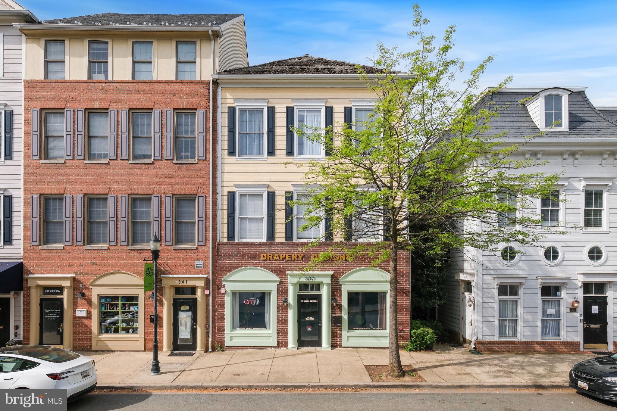 Own Where You Live — And Let the Building Pay for Itself.
Imagine living in a beautifully appointed luxury residence while your tenant downstairs helps cover your mortgage. That is exactly the opportunity this rare mixed-use building in the heart of Kentlands Midtown delivers.
Located in the vibrant core of Kentlands' retail and dining district, this exceptional commercial building offers the ultimate lifestyle investment — live up top in a stunning Mitchell & Best home while generating immediate rental income from the established retail tenant below.
The Income:
The first-level retail space is currently home to Drapery Designs, a well-established, long-standing tenant known for maintaining a clean and professional showroom — and they will remain in place after settlement, providing immediate, day-one rental income.
The Residence:
Above, a beautifully appointed two-level Mitchell & Best home offers 3 bedrooms, 2.5 baths, and over 2,500 square feet of thoughtfully designed living space. The open floor plan blends comfort and style seamlessly, highlighted by a spacious gourmet kitchen with island, formal living and dining areas filled with natural light, and an inviting family room with a cozy gas fireplace. A one-car attached garage and private rear entrance add everyday convenience.
The Location:
Steps from Whole Foods, Starbucks, boutique shopping, and some of the area's best dining — this is Kentlands living at its most coveted address.
The Numbers:
Total building approximately 4,519 square feet of mixed-use space. 
Whether you are an investor seeking consistent revenue potential or an owner-occupant ready to let your building work for you — this is a rare opportunity that simply does not come available often in one of the DC metro's most desirable mixed-use communities.
