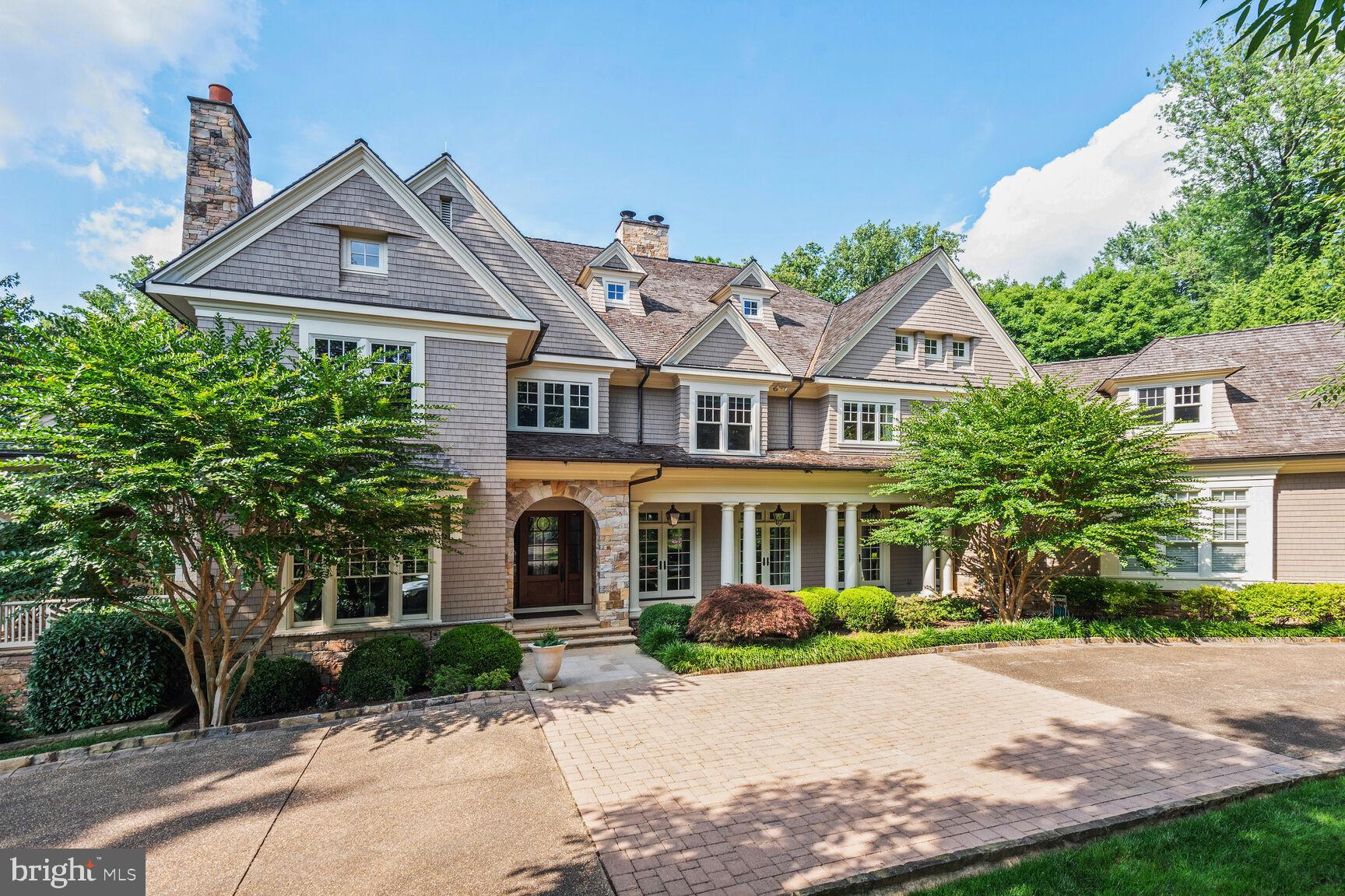 Welcome to one of the most magnificent homes to grace the market in recent years; it is "country club style living in your own home." This extraordinary, fully customized residence was built by the award-winning Sandy Spring Builders, with architecture by the nationally renowned Glenn Fong, and interior design by the acclaimed Gerald Smith.

Step into an amazing open floor plan that showcases exceptional finishes, premium materials, and expert craftsmanship throughout. The home is centered around a grand atrium with a three-story staircase that sits against a wall of glass and a stunning fieldstone profile. At the front of the home sits an elegant formal living room and a stunning, sunlit dining room framed by custom millwork. The impressive great room features beamed ceilings, walls of picture windows, and French doors, providing a perfect setting for both grand entertaining and comfortable living. A phenomenal gourmet chef's kitchen boasts an elliptical center island, top-of-the-line appliances including a La Canche double oven/range with a custom hood, a professional-grade Sub-Zero refrigerator and freezer, and a convenient pot-filler over the stove. The adjoining sun-filled breakfast area, highlighted by a large bay windows, offers a delightful everyday family dining experience. A home office sits conveniently in a quiet space in front of the home with access to the large porch along the front of the home. The main level is further complemented by a custom-designed heated screened porch for enjoyment all four seasons.

As you arrive at the upper level, you enter into the foyer of an incredible primary suite. To your left sits an expansive library/sitting room with extensive built-in cabinets/ bookcases, and straight ahead you find the sleeping area, adorned with a fireplace, that opens to a large private balcony overlooking the oasis serene backyard. A luxurious bath complete with a walk-in glass enclosed shower, standing tub, his and her vanities, his and her fully customized dressing rooms complete this amazing main suite. On this level you can also find a 30-foot long fully equipped gym with large windows along the whole room with a view of the quiet courtyard, inspiring a good workout session. Additionally on this level sit three other large suites with vaulted ceilings, private baths and large walk-in closets. A laundry room located also in this level is also accessible from the main suite for convenience. One of the many highlights of this amazing home is the large executive office suite that can be discovered on a separate secluded portion of the upper level with access from one private corner of the main floor. As you go up this staircase you can enjoy the view of the magnificent backyard and pool from all the windows along the side wall of this amazing space, which also includes built-in bookcases, a private full bath and bar area.

An elevator runs through the center of the home, providing additional convenience and accessibility to all levels. The outstanding, fully finished walk-out lower level is a true entertainment haven, complete with a professional movie theater, a full-height basketball court, a viewing station with a kitchenette/wet bar, an indoor game room, and two additional guest suites with private baths.

The stunning and private backyard is a rare commodity in Bethesda. It features an outdoor kitchen with a beautiful stone breakfast bar, a fabulous 40-foot pool with a spa, and a plethora of mature and specimen landscaping. This special home also includes five garage spaces and a circular driveway, providing ample parking and convenience for residents and guests alike.

The home is ideally located on one of the prettiest streets in the highly desirable Burning Tree community. For the most discerning buyer, this exceptional home offers luxury, privacy, and unparalleled features in a premier Bethesda location. "This property is beyond."