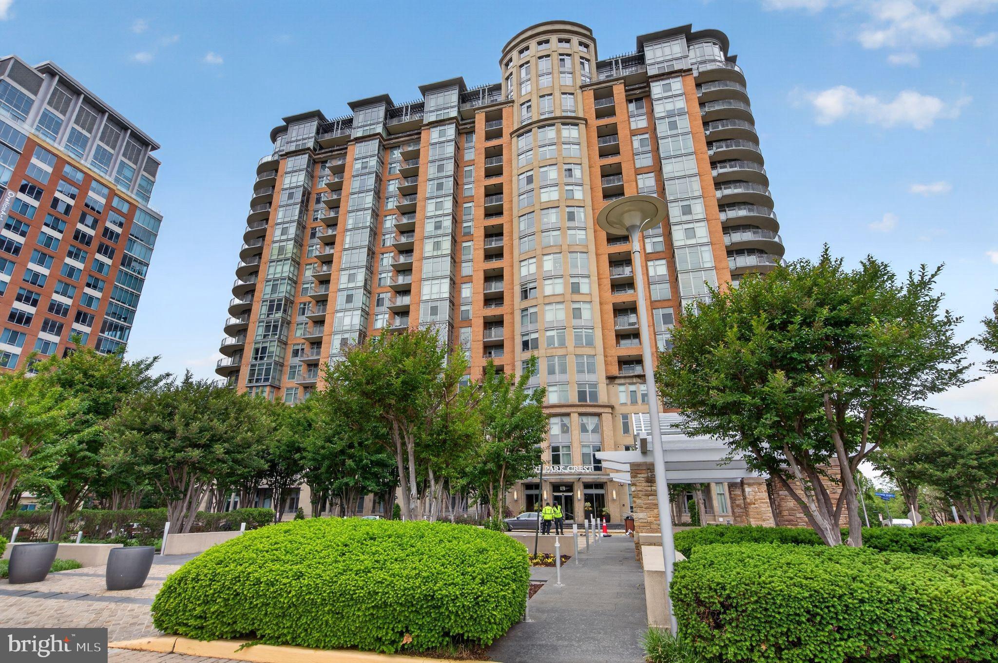 Experience Park Crest, Tysons desirable communities. This pristine residence offers 1-bedroom, 1.5 full baths, and a den convenient for in-home office, a wine room, or a room for your fury pets.  The expansive open-concept living and dining area creates an exceptional setting for entertaining, offering beautifully seamless interior space. Step into a private balcony  and take in the sweeping views. The owners bedroom offers a large walk-in wardrobe and an owners bath complete with a linen closet and a tucked away washer dryer room. The gourmet kitchen is equipped with stainless steel appliances and great wrap around counters great for cooking and entertaining. Residents enjoy a collection of luxury amenities, including a rooftop pool with long panoramic views, a fitness center with private yoga room. Enjoy a game of pool in the billiard room, sit by the fireplace with guests for happy hours, or host a social event in the large club house. Hospitality suites are also available for overnight guests and a meeting room available for conveniences.  24 hour concierge, ample guest parking, and a beautifully landscaped arrival courtyard are all part of the charm.  1 parking and 1 storage included.