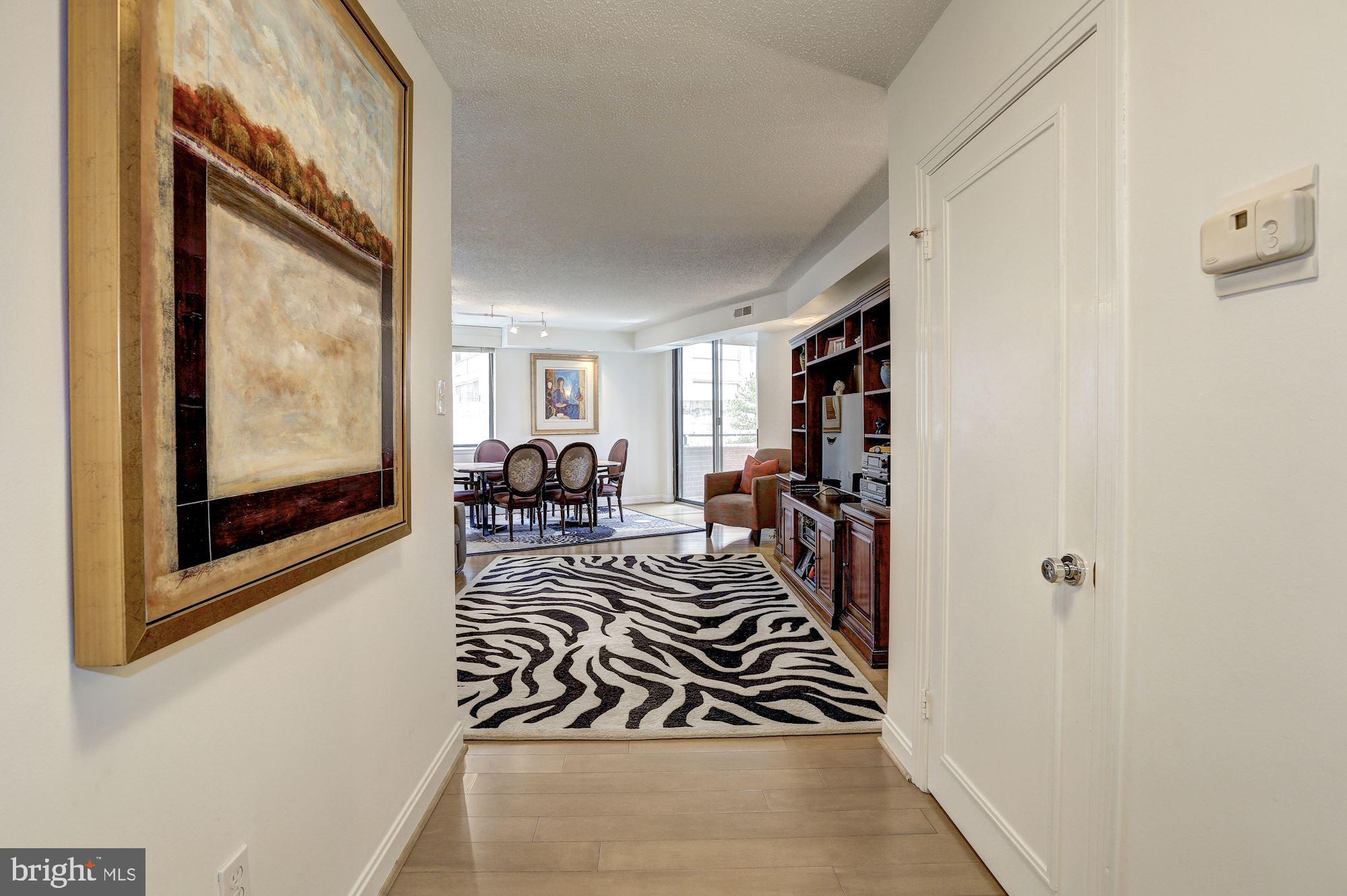 Beautiful, spacious unit in ideal Chevy Chase/Friendship Heights location. 87 Walk Score! Expansive three bedroom, two bath unit with gorgeous finishes such as granite counters, stainless steel appliances, two balconies, custom built wet bar with fridge and wine storage, 24 hour front desk coverage, walk-in closets, master suite with attached office, washer/dryer. Building has outdoor pool, fitness center, sauna,  two assigned parking spaces, four assigned storage units. Extremely reasonable condo fee. This spectacular condo truly has it all.