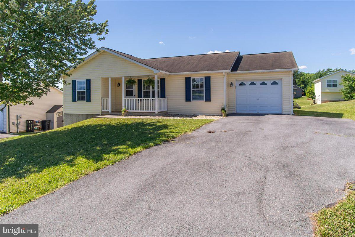 Welcome to this charming rancher in the popular Ridgefield community, offering over 1,900 square feet of finished living space and a flexible layout that provides room to grow. The main level features 3 bedrooms and 2 full bathrooms, including a spacious primary suite with a walk-in closet and private bath. The living room opens to the kitchen and dining area, creating a comfortable and functional floor plan. The finished walkout basement significantly expands the home's living space and offers endless possibilities for a recreation room, media room, home office, workout area, hobby room, or guest space. A rough-in for a future third bathroom provides an opportunity for additional value and customization. Recent improvements include a new HVAC system installed in 2024 and a brand-new rear deck, providing the perfect place to relax, entertain, grill with friends, or enjoy your morning coffee overlooking the backyard. The walkout lower level offers direct access to the yard. Situated on a nice lot with a one-car attached garage & addtl driveway parking, this property offers an excellent combination of space, functionality, and value. Conveniently located just minutes from I-81, Route 9, shopping, dining, schools, medical facilities, and other local amenities, this home is ideally positioned for easy access to everything Martinsburg has to offer. Whether you're searching for your first home, looking to downsize without sacrificing space, or simply want the added benefit of a finished basement, this Ridgefield home is one you won't want to miss.