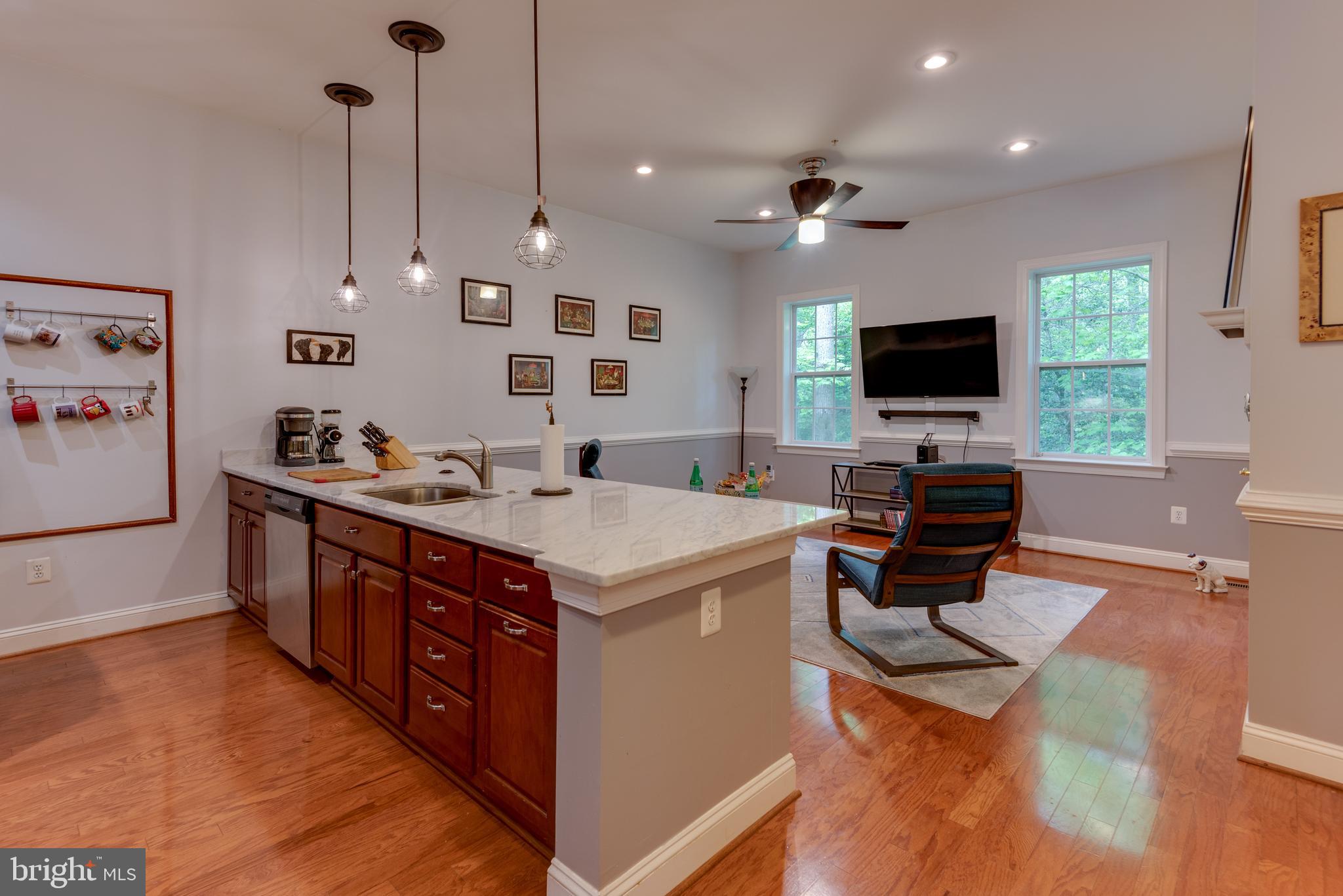 This beautiful home is such a peaceful retreat! Quiet wooded backyard with 3 screened in porches one on each level! Hardwood Floors and Elevator. Gourmet Kitchen with beautiful granite counters this home is such a delight. Garage space and first floor bedroom and bath allows for easy access on the main level. Balcony on the front main and second floor with waterviews of the Wharf in Leonardtown.