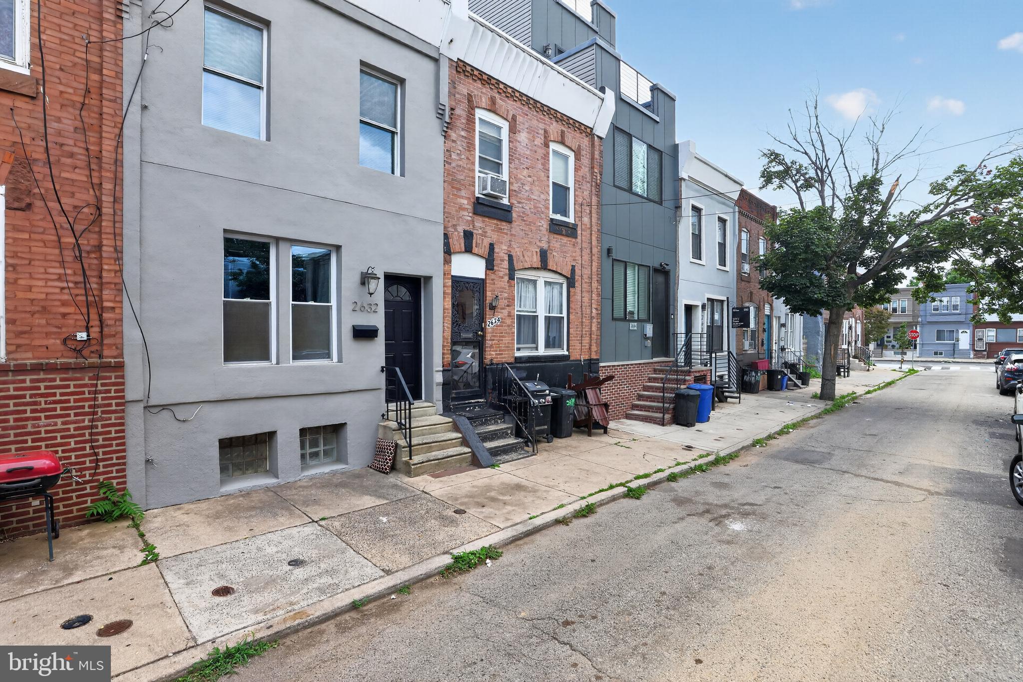 Modern Urban Living at its Finest in South Philly! Fall in love with this nicely reimagined 2-bedroom, 1.5-bathroom contemporary rowhome nestled on a quiet block in the high-demand Grays Ferry neighborhood. Enter the property to a seamless open-concept main floor that greets you with hardwood flooring, an abundance of natural sunlight, and a smartly integrated main-floor powder room for guests. The rear of the home transitions into a nicely appointed kitchen  with quartz countertops, updated cabinetry, stainless steel appliances, and a custom backsplash. From the kitchen, step directly out to your private, fully fenced rear patio—an ideal city setup for summer grilling, morning coffee, or urban container gardening. Upstairs, the second floor houses two bright bedrooms featuring excellent closet storage, alongside a sleek oversized full bathroom accented with contemporary tile work. The bonus living space is found downstairs in the fully finished basement, offering tall ceilings and low-maintenance tile flooring—the ultimate flex space for a quiet home office, private fitness room, or cozy media lounge. Complete with a dedicated laundry area and updated mechanicals, this home is 100% turn-key. Enjoy supreme convenience with a short commute to University City, CHOP, Penn, and the active dining and shopping scenes of Graduate Hospital and Rittenhouse Square. Quick highway access to I-76 makes traveling a breeze. Don’t miss out on this pristine city home—schedule your tour today!