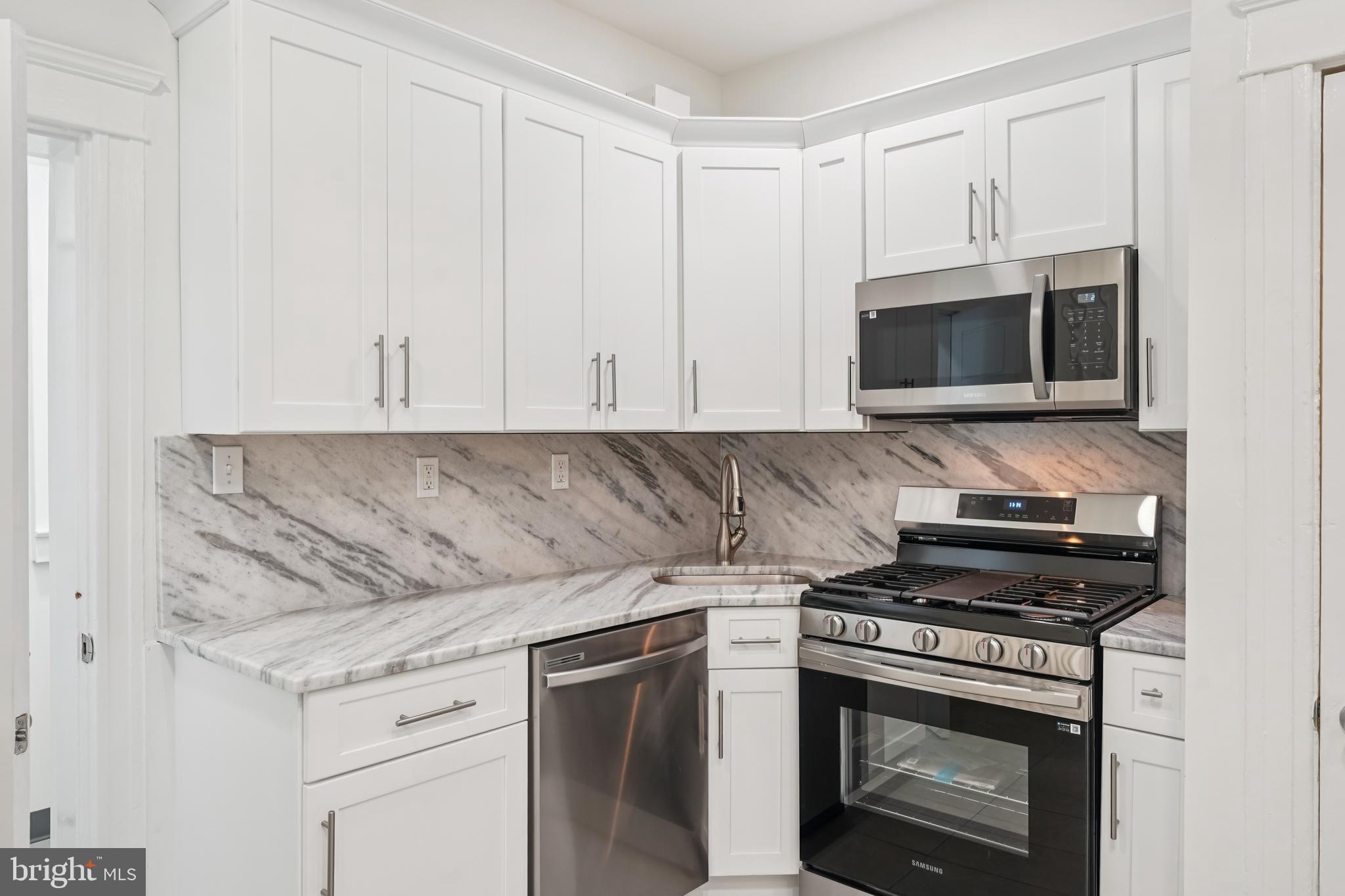 **Price improvement!**   **Gas heat just added!**
Welcome home to this beautifully renovated four-bedroom, one-and-a-half-bath townhome in the heart of Nicetown–Hunting Park, where classic character meets modern comfort. From the moment you arrive, the open front porch invites you to slow down, sip your morning coffee, and enjoy the neighborhood vibe.

Step inside the welcoming vestibule and through a stunning stained-glass door into a bright and spacious living room filled with natural light. Large windows with a built-in sitting area create the perfect spot to curl up with a good book, while the decorative fireplace with a new insert adds warmth, charm, and a cozy ambiance—ideal for relaxing evenings at home. Freshly stained hardwood floors flow effortlessly into the dining area, setting the stage for family meals, celebrations, and everyday moments.

The open kitchen is designed for both function and connection, offering plenty of space for a dining table or center island. Brand-new appliances—including a stove, microwave, dishwasher, and refrigerator—make cooking a joy. A convenient half bath and additional storage at the rear of the kitchen add thoughtful practicality to the space.

Upstairs, retreat to a peaceful second level where a full bathroom with a deep soaking tub and soft recessed lighting offers a spa-like escape. A generously sized rear bedroom provides flexibility as a primary suite or cozy den, while two additional bedrooms at the front of the home are filled with light and feature ample closet space. Each bedroom includes its own ceiling fan for year-round comfort.

The clean, full basement opens up endless possibilities—create a home gym, playroom, entertainment space, or simply enjoy the extra storage. Laundry hookups and a walk-out entrance lead to the rear yard, making indoor-outdoor living and entertaining effortless.

Move-in ready and thoughtfully updated, this home offers the warmth of timeless details with the ease of modern living. It’s more than a house—it’s the place where your next chapter begins. 💛