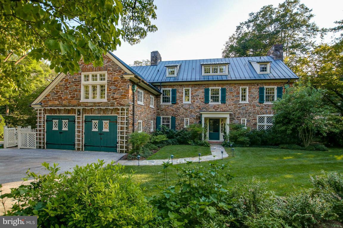 Exceptional historic stone Col on super conven yet incredibly private 4.36 ac. 5 br w 4 1/2 ba. Beautifully designed & appointed in wonderful condn w French drs to patios & covered porch.  MBR w newer bath, dress'g rm. Cooks kit w Thermador 6 burner range, granite, pantry. 1st fl fam rm. Detach'd gar w 2 lg rms for studio, storage. Pool, stone garden walls, Koi pond- charming!! Backs to park