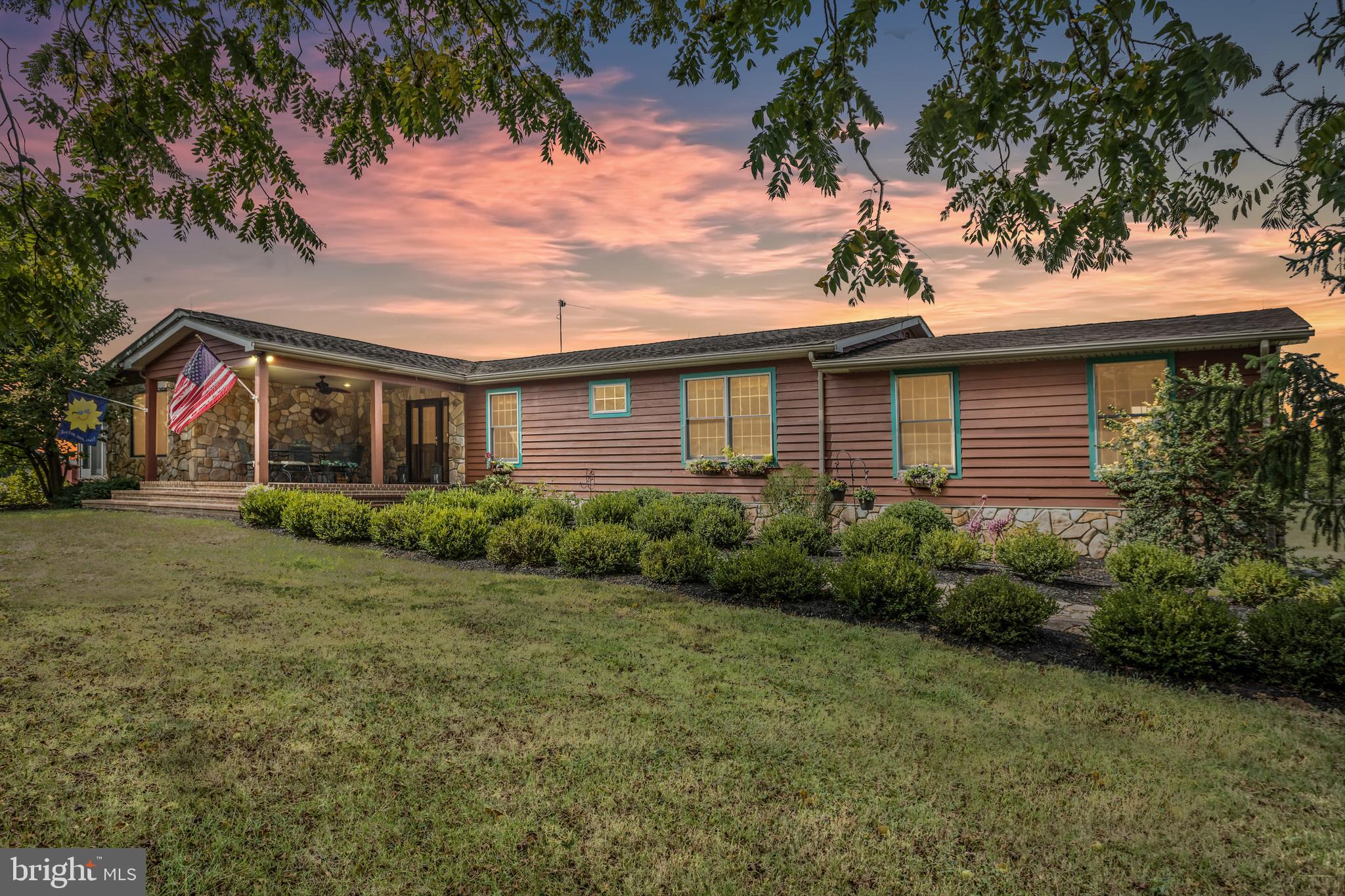 NO COVENANTS OR RESTRICTIONS-NO HOA- Clarke County home on 10 acres with a 5 stall barn just off of Route 7. Once you arrive, you will never want to leave! Mountain  views !! Amazing areas for entertainment both inside and outside of this incredible home with easy access into Winchester or commute to the East. Well planned ranch is bright  with hardwood floors on the main level. The living room has a gorgeous stone fireplace that is fueled by propane, is spacious with large windows. A dining room adjoins the living room, plus the kitchen  has a breakfast area! You will fall in love with the gourmet kitchen!! The island has a  Kitchenaid combination gas ccoktop with electric convection oven (installed in 2020), A separate full GE oven is located in wall cabinetry, refrigerator with icemaker, new dishwasher installed August 2023. The cabinetry is custom cherry with quartz countertops and tile backsplash, deep double sinks, and poplar pantry cabinets. The pantry provides tremendous cabinet space! A small propane fueled free standing stove adds to the charm of the kitchen and will help take the chill off on cold fall and winter days. The deck is off of the kitchen making eating outside simple or enjoy an outside beverage or meal from the front covered entrance porch.  The house is situated with the sunrise over breakfast on the large covered front porch and the sunset on the back deck or downstairs patio. As you enter the Primary suite area, there is a small workspace area, ideal for using your computer, large closet with built-ins and ensuite.  The primary bedroom is filled with charm and has a gas fireplace,  plus an inviting adjoining  sitting room.   The home has a split floor plan,  with two bedrooms and hall bath at the opposite end of the home from the primary suite.  The lower level includes a large recreation room with fireplace and woodstove insert.  A lower level room listed as "other", has been used as a guest room area and there is a full bath on the lower level, plus a workshop area, small media room.   Beautiful all seasons,  property has Redbuds, Roses, Flowering Cherry trees, Holly, Hydrangeas, flowering Magnolia and Evergreens.  Raised garden beds with stone sides, amazing asparagus bed, herbs, and perennial plantings. Invisible fencing surrounds entire back 8 acres with transmitter unit in garage.
The property  has a a 1,000 gallon propane tank and one 500 gallon propane tank for the GE whole house generator and sump pump. The 5 stall barn has water and power, a tack room and upstairs hay loft.
the house has HVAC that was installed in 2014+/- that is a combination unit with propane backup when temperatures drop below freezing. (The septic system is for 3 bedrooms-6 people year round.)  Invisible fencing is on part of the property about 8 acres. Exterior and  some interior painted 2023. All square footage and measurements are approximate only. Buyers should confirm for themselves any information that is important to them. (  Roof replaced January 2024.