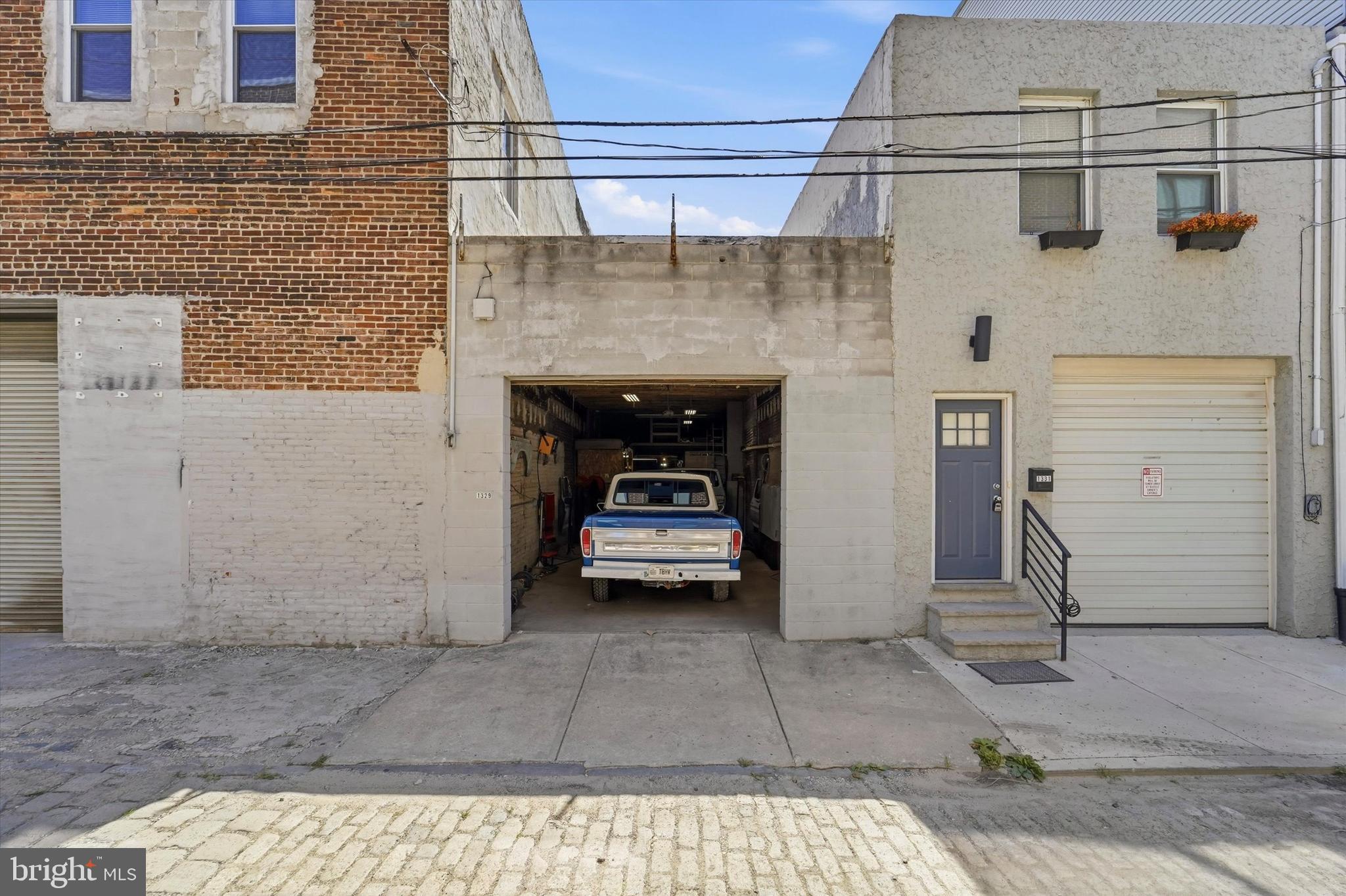 Rare dual-frontage flex building in Point Breeze with drive-in access on two streets — S. 20th and S. Woodstock. This 1,426± SF two-level masonry structure (built 1923) offers two drive-in doors and ground-level garage, storage, or light-industrial space, plus a usable upper level ideal for office or studio. Zoned ICMX (Industrial Commercial Mixed-Use) with RSA-5 residential underlying the block, giving owner-users and contractors secure street-accessible storage today, and investors or developers genuine conversion optionality down the road. Masonry construction, public water and sewer, gas heat. Walkable South Philadelphia location near the Washington Avenue corridor and convenient to I-76 and Center City. A versatile small-bay asset in a dense, appreciating neighborhood. No on-site parking (on-street available). Buyer to independently verify building area, zoning, and permitted uses. Bring your vision — flex, storage, studio, or conversion play.