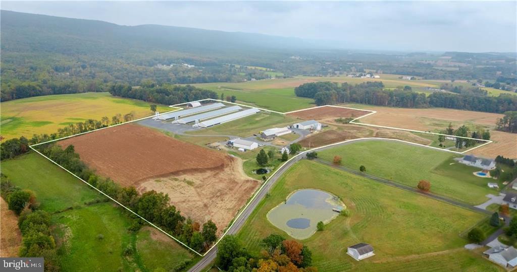 Turn Key Poultry Farm Opportunity!  Rare chance to own a fully operational and income producing chicken farm set on 28 +/- acres in Lynn Township, Lehigh County, PA.  This property is designed for efficiency and profitability offering everything you need to continue production on day one of ownership.  3 well maintained 63'x500' commercial Bell & Evans Farmer Boy Houses with modern equipment, automated feeding, watering systems and ventilation.  Several outbuildings including a heated 50x80 custom stick built workshop garage with two 14x14 bays, three 10x10 bays and poured concrete floor.  Workshop has propane heat, on demand hot water, full bathroom w/shower in addition to an outdoor wood furnace.  60'x100' Equipment Shed with 20'x50' addition, loading dock and storage.  60'x120' Hay storage shed, 33 ft. grain bin, large bank barn and much more.  Approximately 16 tillable acres in addition to Owner's 3 bedroom 2 story Farmhouse residence and separate secondary 3 bedroom helper/worker residence providing perfect live where you work opportunity.  Reliable well water with 3 onsite wells, updated electric and 3 separate backup generators for uninterrupted operations.  Large pond is a bonus!  Don't miss this rare opportunity to step into an established agricultural business with all the infrastructure in place.  Currently in Farm Preservation and Act 319 Clean & Green.  Schedule your private tour today and explore the full potential of the income producing Farm!