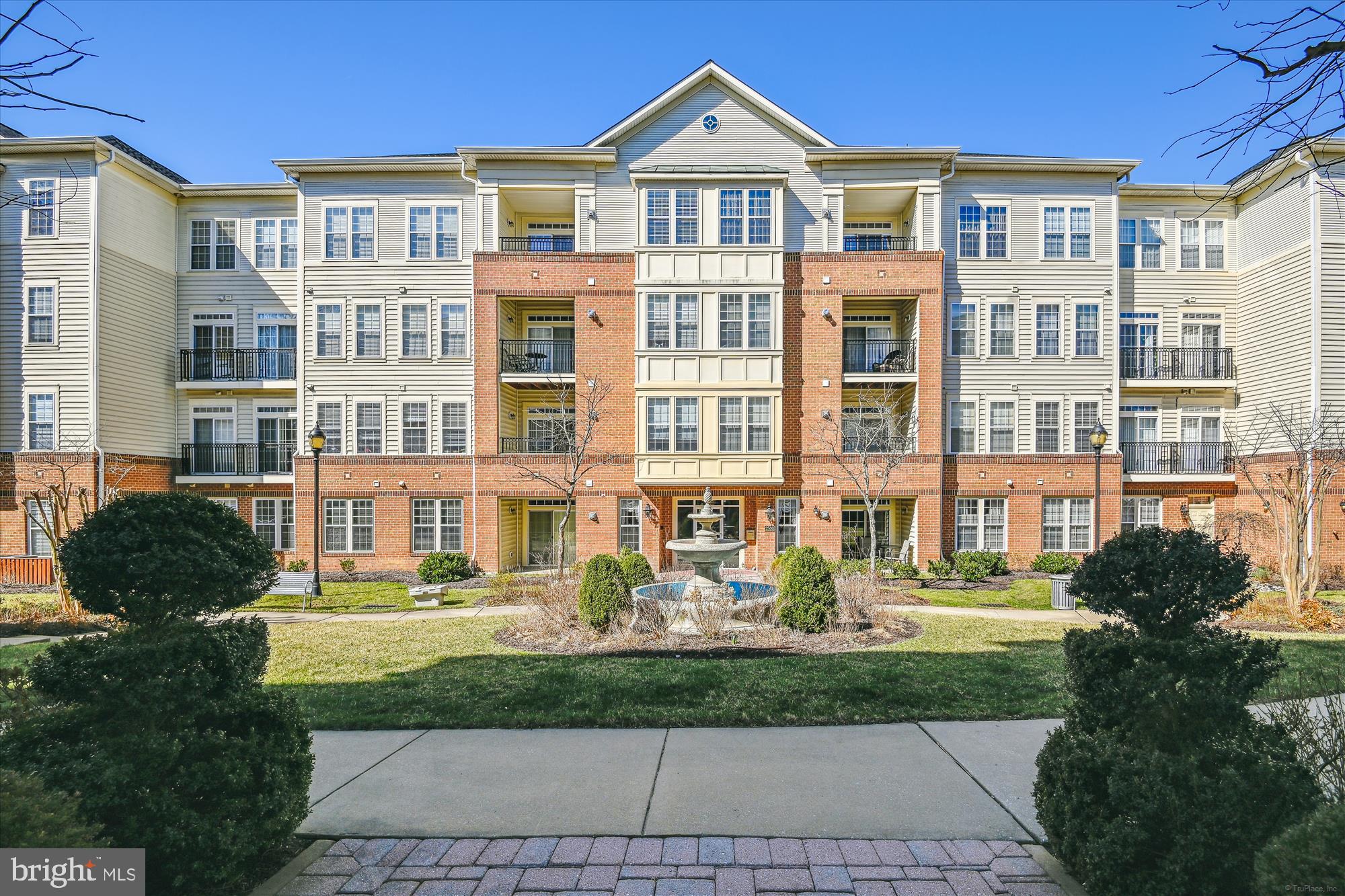 Beautiful corner penthouse condo(4th floor is the top level) in elegant 55+ Community.  Lovely views year round from the balcony off  the living room as well as all bedrooms, the dining room, family room and breakfast area in the Gorgeous Kitchen with  granite counters, great center island , Tile backsplash, under counter lighting, Gas Stove, built-in microwave, 42 inch cabinets, pantry. and hardwood floors.  Gas fireplace in living room.  Crown molding and chair rail contribute to a delightful Dining room. Two bedrooms and a full bathroom off one hallway where the laundry is located.  The Primary Suite is off the foyer on the other side of the condo. Community features activities in the community center, gym and an outdoor pool for summer use.