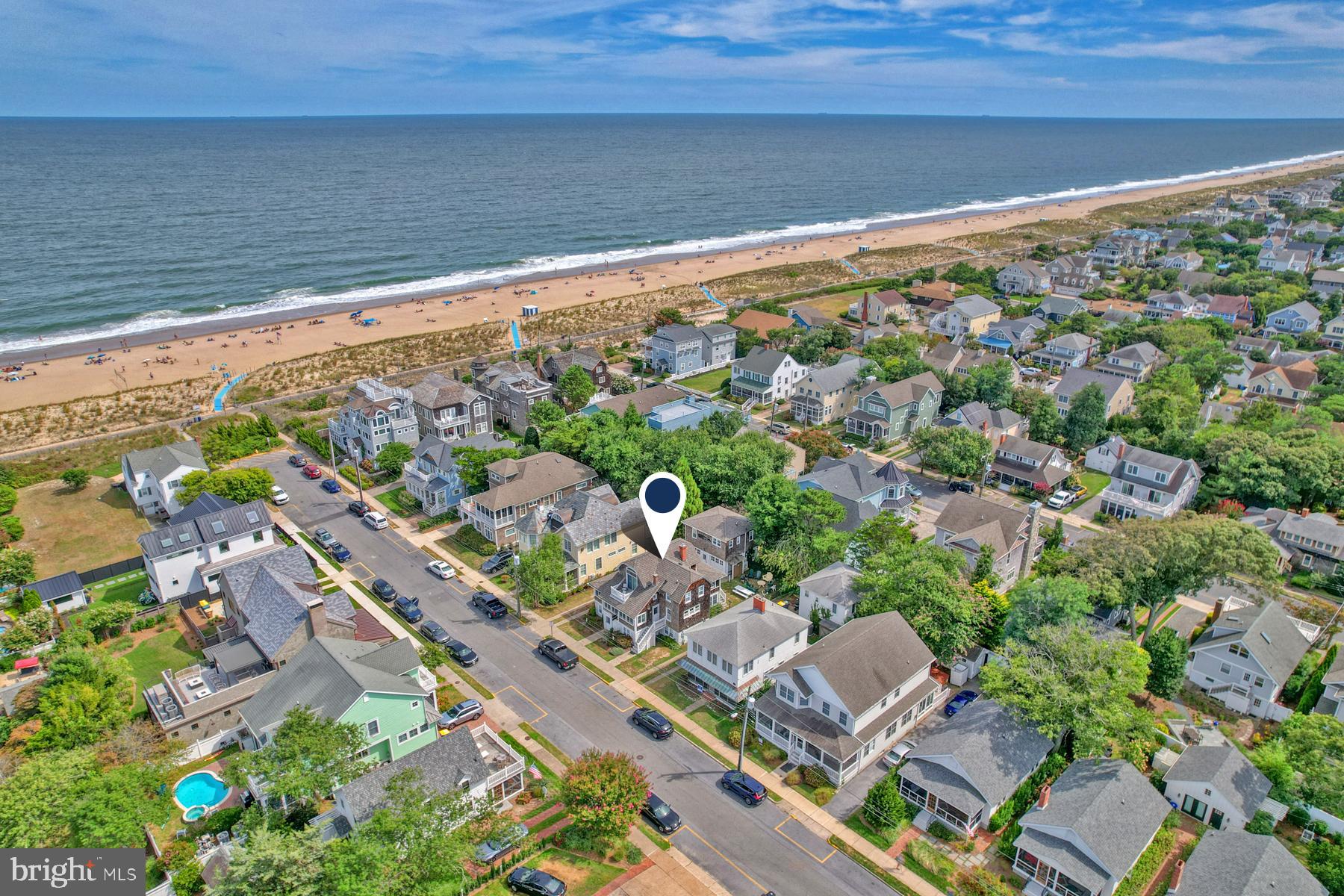Welcome to 6 New Castle Street, an impressive ocean block home in South Rehoboth, just steps away from the beach, boardwalk, and Rehoboth Avenue. This property offers a total of 8 bedrooms and 7 bathrooms across the primary home and a separate apartment above a two-car garage. Featuring unique design elements no longer allowed under current building codes. This historic property has been fully restored to the charm and architectural integrity to reflect its original 1928 construction. Over the past two decades, the primary home and garage apartment have undergone a complete renovation with new vintage fixtures and modern elements while preserving its historic character. The first floor of the main house boasts a large wraparound sunroom, a spacious eat-in kitchen with granite countertops and updated appliances, pantry, an expansive dining room, and five inviting common areas, including a porch with ocean views. Upstairs, you’ll find three well-appointed bedrooms, a private deck offering ocean views, and two full bathrooms. The lower level offers four generously sized bedrooms, three full bathrooms, an additional family room and dining area. Original elements like casement windows were preserved where possible, while modern upgrades were carefully integrated. All wiring was replaced with new copper, and all plumbing has been updated. The walls were fully insulated, and the exterior was fully updated with western red cedar siding. The roof was upgraded with durable 50-year CertainTeed Grand Manor shingles, designed to withstand high winds, and the HVAC system was fully updated with three high-efficiency central units, one per floor. The rear garage apartment was completed with an equally meticulous renovation, including the addition of a brand-new central air system in 2024. A key feature of this property is its grandfathered design, which allows for three stories— something no longer permitted in new construction, resulting in 3,800 square feet of living space while preserving the lawn. The property also includes a two-car garage and a total of 7 off-street parking spaces. The oversized lot is 55 feet wide by 100 feet deep, with a shared easement for additional off-street parking. Located just five houses from the beach and a short walk from downtown, this property offers the perfect blend of historical character, modern comfort, and an unbeatable location. At the rear of the property, a 2-car garage includes a 576 square foot, 1-bedroom, 1-bathroom apartment on the second floor with its own living room and kitchen. Exterior highlights include an outdoor shower and seven off-street parking spaces. With a proven strong rental history, this home is a fantastic investment opportunity. Rent one unit while enjoying the other as your personal beach retreat. Don’t miss the chance to own this extraordinary piece of South Rehoboth!