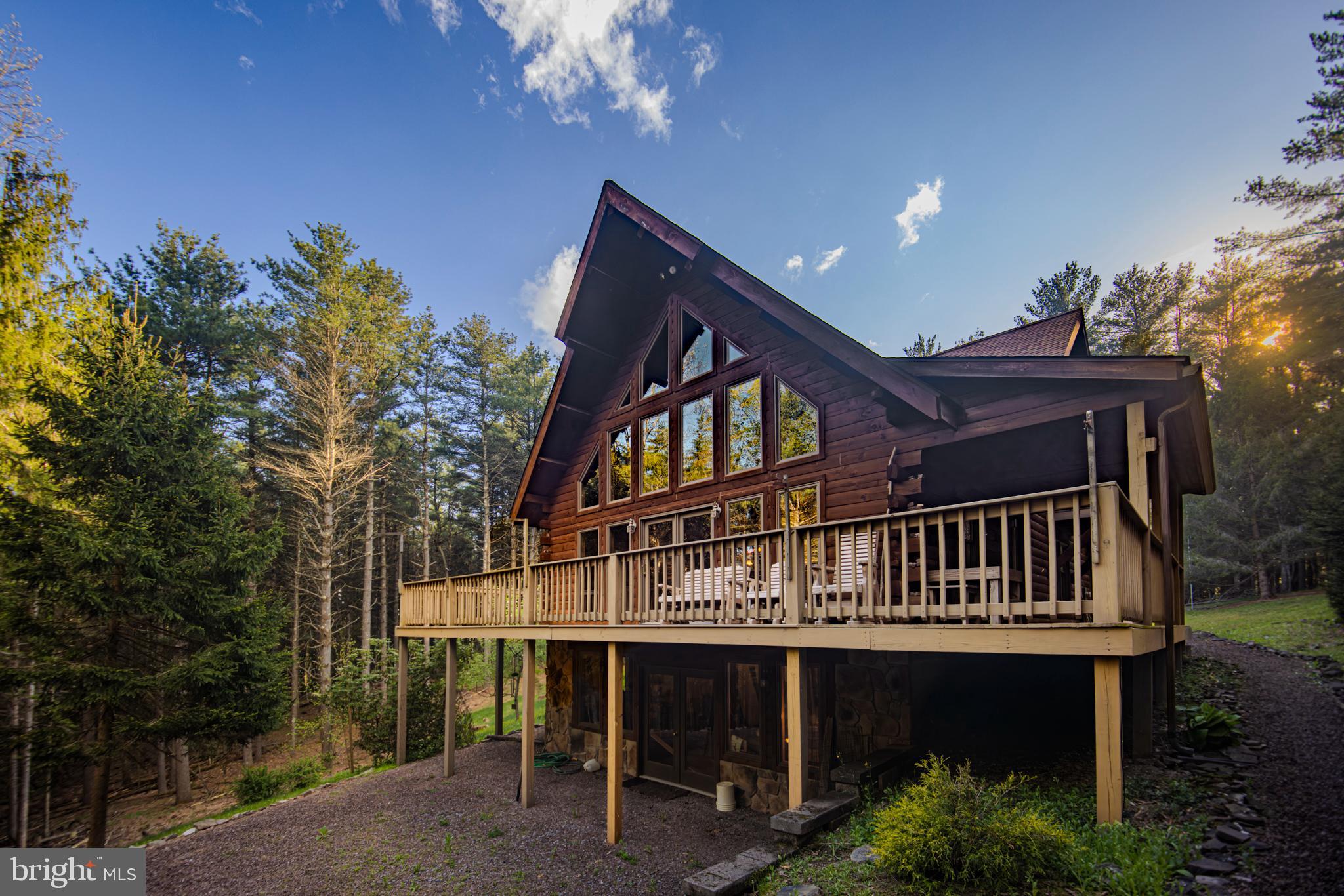Welcome to your dream retreat! This meticulously maintained 3-bedroom, 2-bathroom chalet offers a perfect blend of comfort and nature, set in a truly private setting just a short stroll from New Germany State Park.

As you approach, you'll be enchanted by the inviting wrap-around porch that provides stunning views of the lush landscape and local wildlife – a true nature lover's paradise. Step inside to discover an open-concept living space bathed in natural light, featuring modern amenities, high-quality finishes, and a cozy atmosphere.

For your convenience, this home boasts a spacious 2-car garage and essential central air conditioning to keep you cool during the warm months. Enjoy peace of mind with a whole home generator, ensuring you're always ready, no matter the weather.

The property is a horticultural delight, with abundant blueberry bushes and apple trees perfectly situated on the grounds, offering fresh produce right at your fingertips. The walkout basement leads you to a charming firepit area, perfect for cozy evenings spent with family and friends under the stars.

This home can convey "turn-key," complete with everything needed for you to move in on day one or to cater to Airbnb guests with ease. Don't miss the unparalleled opportunity to own this beautiful chalet that combines luxury living with the beauty of nature! Schedule your private tour today and experience the tranquility this unique property has to offer.