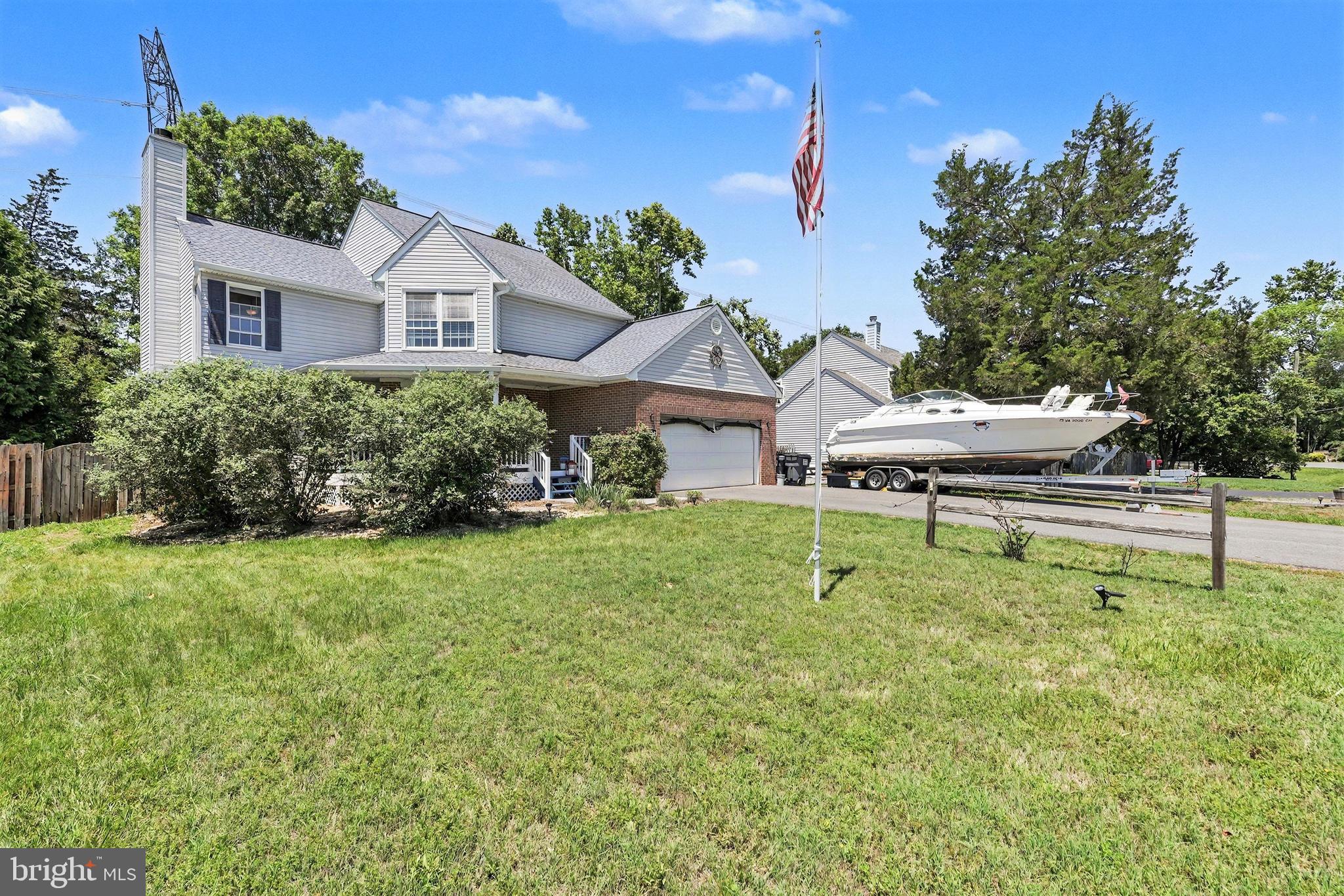 Waterfront Living on Aquia Creek! Move-In Ready 3BR, 3.5BA Brick & Vinyl Colonial with a Private Dock, Main Level Bedroom Suite, Tiki Bar & Boat/RV Parking in amenity-filled Aquia Harbour! Highlights include improved waterfront with seawall, private dock, approximately 4' mean low water and excellent access for boating, fishing, kayaking and water recreation. Two-car-wide driveway plus side parking pad for a boat, RV or trailer, covered front porch, architectural shingle roof, dual-zone HVAC and water heater (2018).  Inside, hardwood flooring spans much of the main level. The family room features a wood-burning fireplace and deck access, while the living room offers crown molding, shiplap-style accent walls and atrium doors to the deck. The kitchen includes a pantry, Bosch dishwasher, built-in microwave and breakfast area with deck access. A main-level bedroom suite provides flexible one-level living with a walk-in closet and updated full bath. A renovated half bath and laundry room complete the main level.  Upstairs, the primary suite features hardwood flooring, walk-in closet, private balcony with water views and a separate sitting room/home office. The luxury bath offers dual vanities, jetted soaking tub and oversized shower with multiple body sprays. An additional bedroom and updated hall bath complete the upper level.  Outdoor living shines with a tiered deck, retractable awning, fire pit area, fenced backyard, powered shed and covered tiki bar with new roof. The Improved Waterfront Features a Seawall, Private Dock & Direct Access to Aquia Creek and Beyond for Boating, Fishing, Kayaking & Waterfront Enjoyment right from your backyard. Additional features include a two-car garage with epoxy floor and shelving. Located on one of Aquia Harbour's most desirable streets near the community garden, walking trails and front gate access. The Abundant Aquia Harbour Amenities include 24 Hour Manned Front Gate + Residents Only Rear Gate; Two Pools; State Certified Police Force; Fire Dept; Marina w/Boat Ramp & Fishing Pier; Kayak/Canoe Launches; Golf Course w/Pro Shop, Putting Green, Driving Range & the World Famous Clubhouse @ Aquia Harbour Restaurant; Dog Park; Horse Stables, Riding Areas/Trails & Pens; Secure Storage Lot; Community Garden; PreSchool; Fishing Park; 8 Other Parks w/Tot Lots, Tennis & Basketball; Nature Park Like Surroundings with Tons of Wildlife including Deer, Fox & Bald Eagles Above! Don't Forget About the Community Events, including the Independence Day Celebration w/Parade and Fireworks, Oktoberfest, Outdoor Movies, and More!