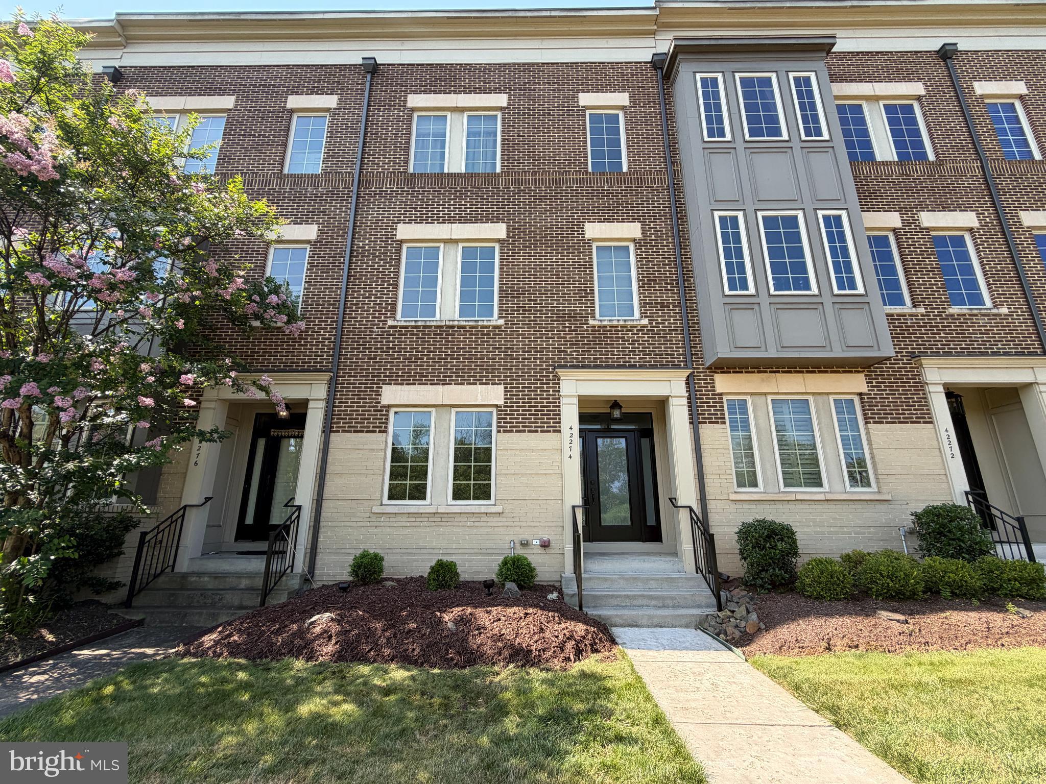 Welcome to this beautifully refreshed Miller & Smith Brownstone, offering approximately 2,512 square feet of thoughtfully designed living space across three finished levels. This move-in-ready home features four bedrooms, three full baths, and one half bath, combining timeless style, everyday comfort, and the ease of low-maintenance living.

Freshly painted from top to bottom, the home has been thoughtfully refreshed with newly refinished hardwood floors, brand-new carpeting.  The entry level offers a spacious recreation room, a full bath, and a fourth bedroom, guest suite or home office.

The open-concept main level is designed for both comfortable everyday living and effortless entertaining. The kitchen features stainless steel appliances, granite countertops, a large center island, stylish pendant lighting, and ample cabinet space, flowing seamlessly into the dining area and inviting family room. A striking floor-to-ceiling stone gas fireplace serves as a warm and inviting focal point, creating the perfect gathering space for family and friends.

Step outside onto the private balcony overlooking mature trees, where a retractable awning provides welcome shade on sunny afternoons, making it the perfect place to enjoy your morning coffee or unwind at the end of the day.

Upstairs, the spacious primary suite offers a relaxing retreat with an en-suite bath, and two walk in closets.  Two additional bedrooms, a third full bath, and a conveniently located laundry room complete the upper level.

Additional highlights include a low-maintenance exterior and access to Brambleton's outstanding HOA amenities, including Verizon Fios high-speed internet and cable TV, lawn maintenance, trash and recycling service, five outdoor pools, miles of scenic walking and biking trails, numerous parks and playgrounds, pickleball and tennis courts, and an active calendar of community events.

Perfectly positioned directly across from Brambleton Golf Course, this home also enjoys one of the community's most desirable locations. Just a short stroll away, Brambleton Town Center offers an outstanding selection of restaurants, shopping, entertainment, fitness, a public library, movie theater, seasonal events, and everyday conveniences—making it easy to enjoy everything this vibrant community has to offer right outside your door.