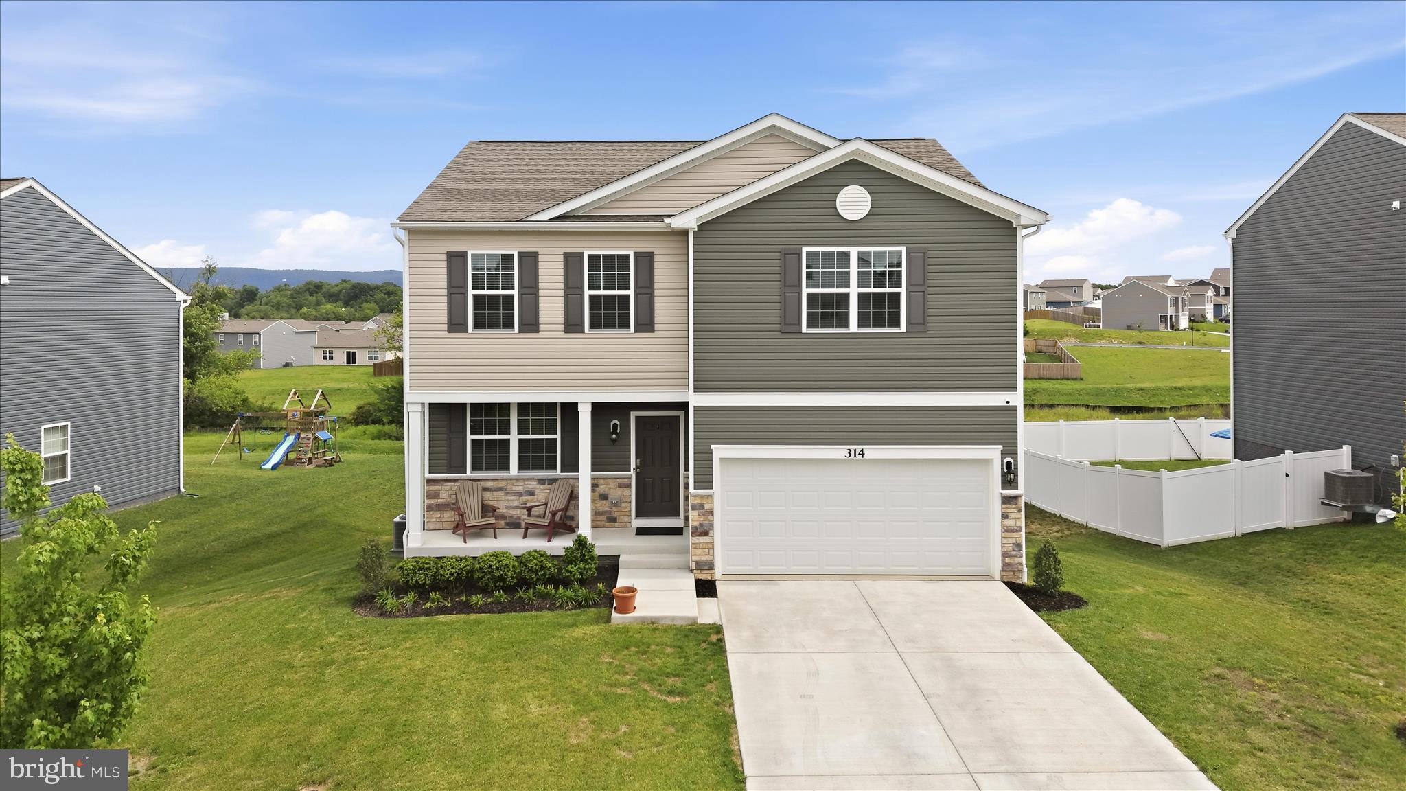 Enjoy mountain views from this like new and meticulously maintained 3-year-young Colonial.  This home offers 4 bedrooms, 2.5 baths, a main-level office/flex space, and a thoughtfully designed floor plan perfect for modern living. The spacious kitchen features a center island overlooking the family room, a large pantry, upgraded refrigerator, and upgraded kitchen faucet. Custom blinds throughout add style and convenience.  The partially finished basement provides additional living space and future expansion potential with a framed rough-in bathroom already in place—a rare feature in this neighborhood where few homes offer basements.  Enjoy breathtaking mountain views from the expansive 16' x 20' Trex deck with stairs leading to the flat backyard and no close neighbors behind. Seller-added upgrades include an active radon mitigation system, water softener, covered exterior vents to prevent bird nesting, and underground-routed downspouts to dissipate water away from the foundation. Conveniently located along one of the Eastern Panhandle's most accessible commuter routes, this exceptional home combines comfort, convenience, and stunning scenery.  Future community tot lot to come.  This home shows like new.  Schedule your showing today!